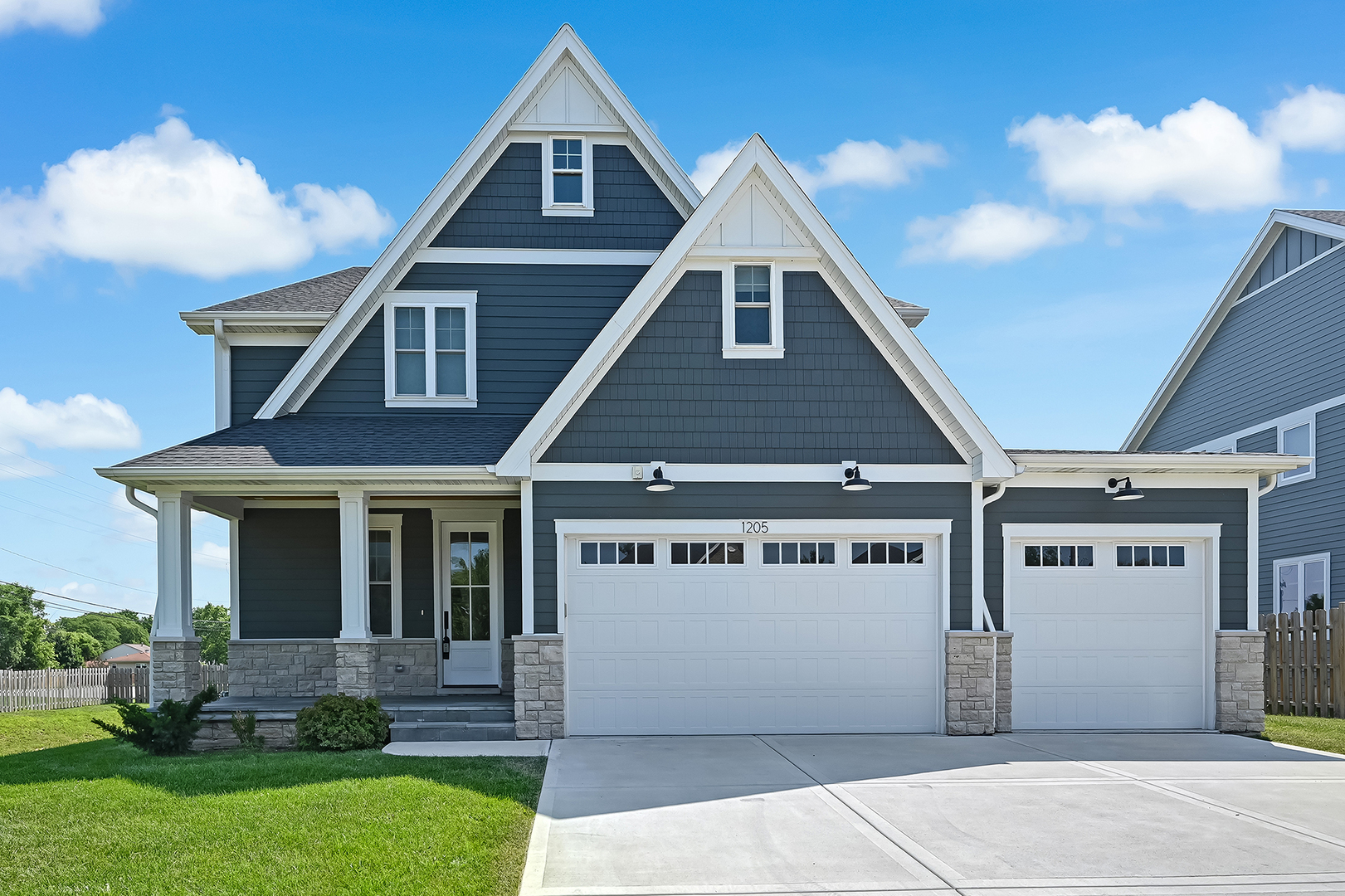 Welcome to 1205 Ridge Road - a stunning 2023-built home that offers all the perks of brand-new construction. This thoughtfully designed 2-story residence spans 3,475 square feet, featuring 4 bedrooms and 3.1 bathrooms, and is brimming with high-end finishes and modern convenience. Step inside to find wide plank hardwood floors that flow seamlessly throughout the open layout. The designer staircase makes an elegant statement, while the inviting family room, complete with a gas fireplace, provides a cozy retreat. The gourmet kitchen is a showstopper, boasting an oversized quartz island, premium stainless steel appliances, and an expansive walk-in pantry. The breakfast nook with built-in banquette seating is perfect for casual mornings, while the formal dining room, adorned with custom moldings, sets the stage for memorable gatherings. The primary suite is a luxurious haven, offering a soaring volume ceiling, a spacious 14' x 11' walk-in closet, and an indulgent en-suite bathroom with heated floors, a spa shower, and a free-standing soaking tub. The second bedroom includes an en-suite bath and walk-in closet, while the third and fourth bedrooms share a well-appointed Jack & Jill bathroom, each with ample closet space. Outside, you'll find a private backyard oasis with a paver brick patio, grilling area complete with a natural gas line, and a cozy firepit-ideal for relaxing or entertaining. Additional highlights include a 3-car attached garage, a mudroom with cubbies and a coat closet, a covered front porch with charming beadboard ceiling, and a 2nd-floor laundry room for added convenience. The full unfinished basement with rough-in plumbing is ready for your personal touch, and the home features dual-zoned A/C and heating with an Aprilaire Humidifier to ensure year-round comfort. Perfectly situated near shopping, dining, parks, and expressways, this home combines the luxury of new construction with the ease of being move-in ready. Don't wait-this is your chance to enjoy modern living without the hassle of building from scratch!