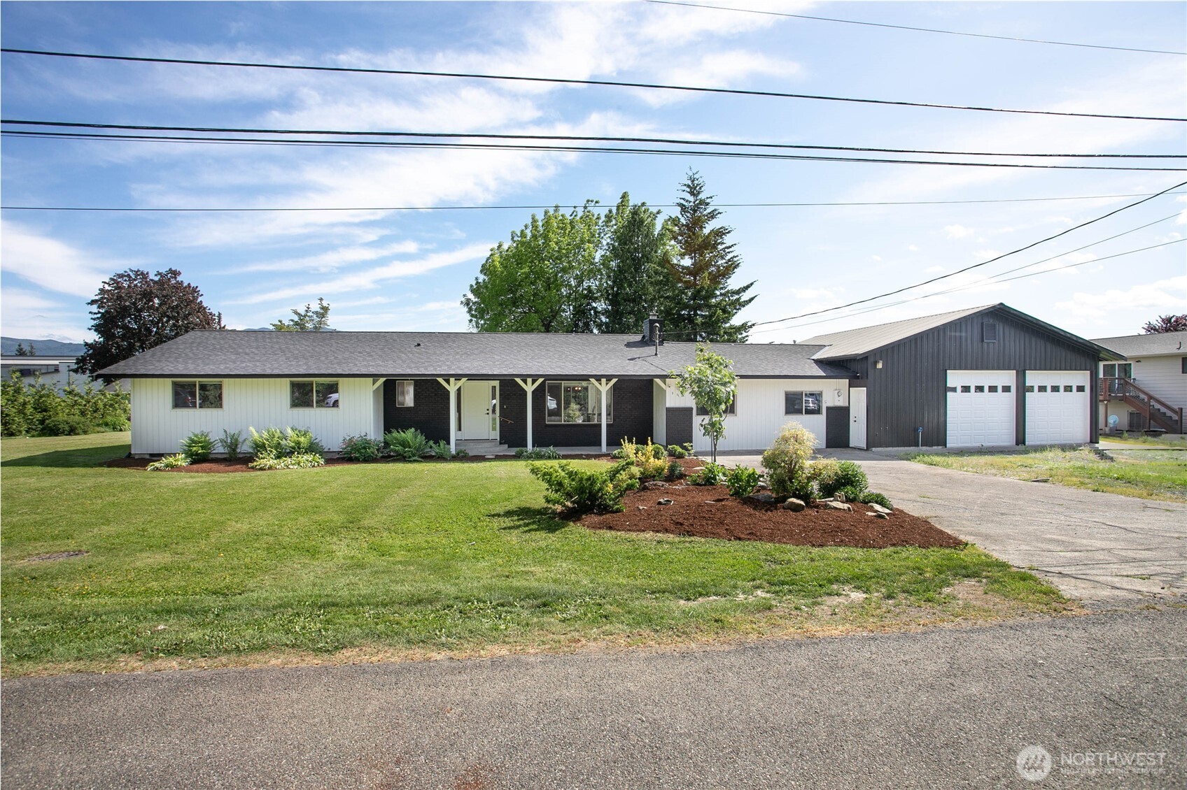 Welcome home! Beautifully remodeled rambler on .5 acre with attached 2 bay shop ready for new owners. Tucked away on quiet outer town street with frequent wildlife visitors. Plenty of parking with extra-long driveway & full gravel area in front of shop bays. Well-appointed design choices from exterior paint to interior finishes throughout. Inviting and spacious living room with cozy shiplap surround gas fireplace is semi-open to sunny bright dining room just off kitchen. Fully updated kitchen includes custom cabinets, quartz counters, full tile backsplash, stainless steel appliances, 2x pantry cabinets w/pull out drawers, eat-in peninsula & more! Owner's suite includes ensuite 3/4 bathroom w/dual vanity and walk-in closet. LVP flooring throughout entire home - zero carpet! Extra-large utility room near bedrooms, near new w/d included & tons of cabinet/closet storage. 2 more flex rooms & currently used as 4th bdrm on opposite side of home. Nearly BN roof & AC. Huge 2 bay attached shop with 3/4 bathroom and double door access to spacious backyard. Additional large outbuilding, covered patio and enormous yard complete this move-in ready home. Unbeatable value for the price!