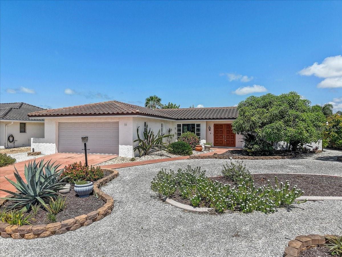 Englewood Isles -Highly sought after WATERFRONT community, minutes from Lemon Bay and easy access to Intracoastal waterway with no bridges. JUST 3 MILES TO THE BEACH. Home features the Florida Coastal Lifestyle. Mature landscaping with minimal maintenance and NO LAWN TO MOW!! Home has a SPLIT FLOOR PLAN with OPEN CONCEPT LAYOUT for convenience and entertainment. Dining/Living/Kitchen combo with full views of the front and pool area through the large front windows and sliding glass doors. The primary bedroom has an en suite bathroom with walk-in shower, direct access to the pool, a large walk-in closet with sparkling floors and comfortable space. The  guest bedroom has a built in closet and walk through bathroom shared by the bedroom and available to guests through the hall access with updated tiled walk-in shower and water closet for privacy. Pool area has travertine decking with abundant space for sun bathing and larger dining area for those special dinner parties. The family room is a bonus which can be utilized for an office or turned into an additional 3rd bedroom space.  Many updates - New AC 2023, Washer/Dyer -2021, Pool pump 2019, Hot Water Heater 2023 Re-pipe 2016, Pool Resurface 2015, New Electrical Panel 2021, Garage Door 2020, TILE ROOF, Updated kitchen, Updated luxury tile throughout.  The ENGLEWOOD ISLES is an amazing community with a marina, heated/cooled swimming pool, hot tub/spa and private boat docks with direct access to FORKED CREEK- a salt water canal, LEMON BAY- an Intercoastal Waterway and out to GULF WATER. Just minutes to ENGLEWOOD BEACH, MANASOTA KEY BEACH, golfing, shopping, Lemon Bay Plaza, VENICE ISLAND and OLD ENGLEWOOD VILLAGE. PRIME PROPERTY, PRIME LOCATION!!!