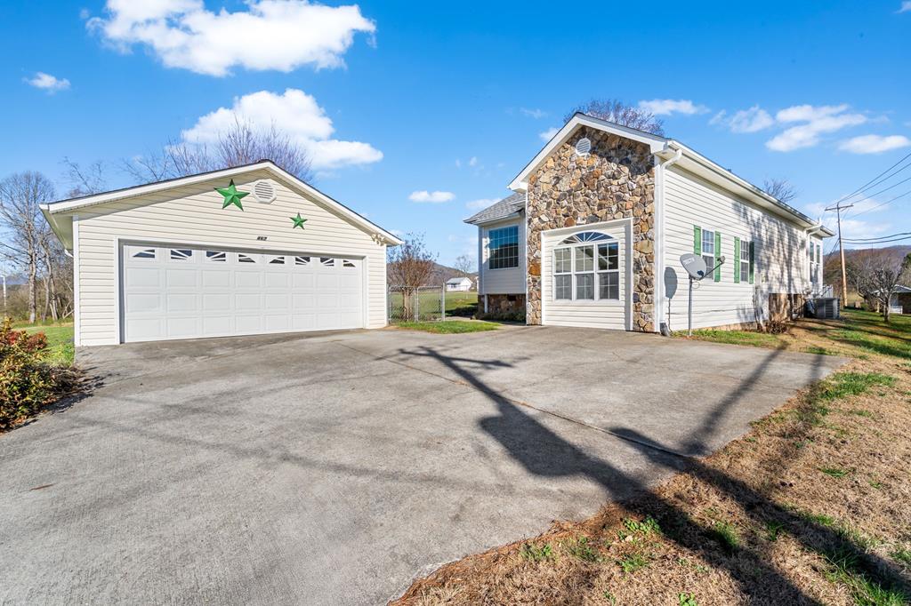 Discover the charm of this beautifully maintained home, perfectly nestled among peaceful farmland and quiet private neighborhoods. Enjoy the convenience of a fenced dog lot—great for pets or play—along with a spacious two-car garage/workshop and a concrete driveway. Inside, the open-concept living and dining area flows seamlessly into a bright kitchen featuring granite countertops and an elegant skylight. The home offers two comfortable bedrooms and two well-appointed bathrooms, including a generous primary suite with double sinks and a granite vanity. Relax in the 2 different sun-filled sunrooms or take advantage of the practical mudroom designed with busy families in mind. Additional updates include new sliding doors, city water, and a roof replaced in 2024. Ideally located just 5 minutes from Murphy Medical Center and convenient to HVRC, local vineyards, whitewater rafting, Blue Ridge, and Blairsville, GA—this property offers the perfect blend of comfort, functionality, and lifestyle. Come see this beautiful home today!