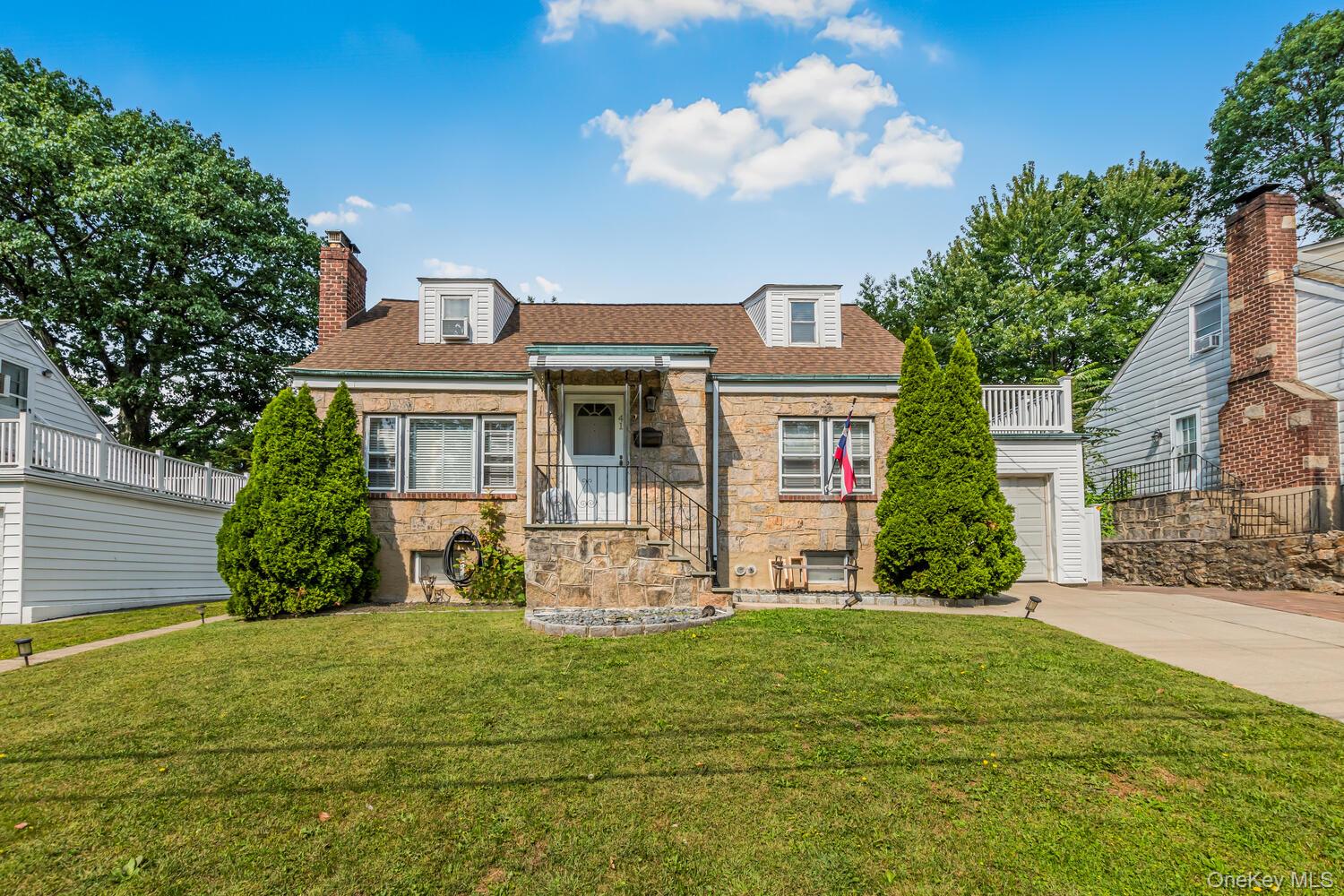 Discover this stunning 3-bed, 2.5-bath Cape Cod style Home blends timeless charm with modern luxury nestled in the heart of East Yonkers on a lovely tree-lined street. Impeccably maintained and truly move-in ready, this picture-perfect residence offers the ideal blend of suburban tranquility and upscale living. Situated on a beautifully landscaped, fully fenced property, the lush gardens and manicured lawns set a peaceful tone from the moment you arrive. A gorgeous brick paver patio provides the perfect setting for outdoor entertaining or quiet evenings at home. Step inside to discover a warm and inviting living room complete with a cozy fireplace, and an updated chef’s kitchen featuring rich cherry wood cabinetry, premium appliances, and thoughtful design. Two spacious bedrooms and a luxurious full bath complete the main level - ideal for guests, family, or flexible work-from-home spaces. Upstairs, your private retreat awaits you featuring a spacious and exquisitely designed primary suite with a spa-like bathroom and a custom-designed wardrobe plus access to your own private balcony-the ultimate in comfort and style. The fully finished lower level expands your living space with a versatile family room, home office area, powder room, laundry, utility space, and abundant storage plus access to the backyard. Recent improvements include new Central Air split unit system, Roof, updated Bathrooms, new hardwood flooring, new brick paver driveway / sidewalk plus much more Step outside to your own serene Oasis -whether you’re relaxing in the garden, hosting friends on the patio, or enjoying the long Summer evenings. Truly a commuters dream- just minutes to buses, trains, shopping centers, major parkways and all within 25 minutes of Manhattan. This home is a rare opportunity where luxury, comfort, and commuter convenience meet in perfect harmony.