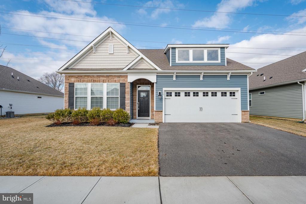 Just like new home located in a highly desirable 55+ community featuring the popular and rarely available Azalea Model with stone accents. This 3 bedroom, 2 bath home offers a stunning open floor plan ideal for everyday living and entertaining. The kitchen features white cabinetry, quartz countertops, and opens to spacious living areas with warm luxury vinyl plank flooring throughout.The isolated primary suite includes a large closet and private en-suite bath. Two nicely sized guest bedrooms share a full  bath. Additional highlights include abundant closet space, recessed lighting throughout, and a peaceful rear yard.Enjoy close proximity to downtown Moorestown along with community amenities including a clubhouse and outdoor pool. Move-in ready and low-maintenance living at its best.Enhanced Photo virtual Furnishing in 3 photos.