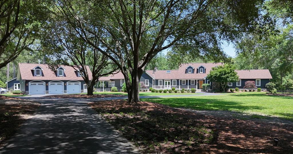 Tucked away in the prestigious Gatlin Creek Farms community, just minutes from downtown Thomasville, top schools, and shopping, 1477 Fox Meadow Lane offers a rare combination of luxury living, privacy, and thoughtfully designed equestrian functionality. Currently enjoyed as a private estate, this exceptional property spans 10.81 beautifully improved acres and offers approximately 5,808 square feet of heated and cooled living space, including the main residence and guest house, plus there's a climate-controlled storage room above the garage and a heated and cooled home office in the barn. The custom-built main home encompasses approximately 4,848 square feet and is finished to a high standard throughout, with heart pine floors, refined lighting, and multiple living spaces designed for both everyday comfort and elevated entertaining. At the heart of the home, a fully renovated chef's kitchen features marble countertops, Cafe appliances, a gas range, and double ovens, flowing seamlessly into inviting living and gathering spaces. The den is anchored by a stone fireplace and finished with a white pine ceiling, creating a warm yet sophisticated atmosphere. A fully wired theater room and a sun-filled poolside living area further enhance the home's effortless indoor-outdoor lifestyle. The primary suite serves as a true retreat, offering a spa-inspired bath with freestanding soaking tub, glass-enclosed shower with dual and double-sided shower heads, marble finishes, and custom closet organization. An adjoining private study or sitting room with fireplace and French doors provides flexibility for a home office, private den, or optional fifth bedroom. The main home includes four bedrooms and three-and-a-half baths, complemented by a one-bedroom, one-bath guest house complete with kitchen and laundry, ideal for extended stays or private accommodations.   Outdoor living is equally refined, with a resurfaced saltwater pool, new decking, professional landscaping, and a picturesque oak-lined drive that sets the tone for this private, resort-style estate. While impeccably suited for the equestrian enthusiast, the property transcends the traditional horse farm feel. Four paddocks are fenced and cross-fenced, with water run throughout the property, and a custom four-stall barn offering a wash area, tack and workshop space, and a heated and cooled barn office with direct-connect fiber internet.   Residents also enjoy over 100 acres of common-area riding trails, perfect for afternoon rides through well-maintained paths featuring natural shade and gentle terrain. The entire property is supported by a whole-property, water-cooled Kohler generator, ensuring uninterrupted comfort and peace of mind.   This estate is thoughtfully set up for horses, yet make no mistake, this is quality, resort-style living first and foremost. The home is custom-built, top-of-the-line, and the true focal point of the property, offering refined luxury whether you own horses or not. This is not an average property, nor is it overtly "horsey." It is a rare opportunity to enjoy space, privacy, and craftsmanship in one of Thomasville's most desirable communities, where luxury, land, and lifestyle come together effortlessly.