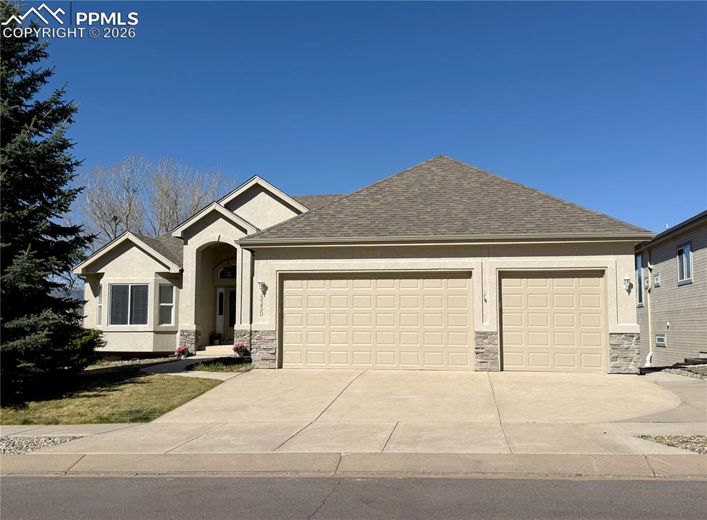 Don’t miss this beautifully updated WALK-OUT rancher offering over 4,200 square feet, 5 bedrooms, 4 bathrooms, an office or formal dining room, and an oversized 3-car garage, with stunning Pikes Peak VIEWS from the home, located in the highly desirable Dakota Ridge neighborhood with a swimming pool, pickleball and tennis courts, a park, and year-round events. The striking exterior showcases low-maintenance STUCCO with a new color coating (2026), complemented by a class 4 NEW ROOF, gutters, and downspouts (2026), along with a newer composite DECK (2025). Inside, soaring vaulted ceilings and abundant natural light enhance the spacious living room, anchored by a cozy fireplace and a dramatic wall of windows framing breathtaking Pikes Peak views, with direct access to the deck—perfect for relaxing or entertaining. The main level includes three bedrooms plus an office or formal dining room, an inviting eat-in kitchen with solid wood floors and a pantry, and a private primary suite featuring incredible views, a five-piece bath with its own fireplace, and a large walk-in closet. The walk-out basement offers a generous recreation room with a fireplace and wet bar, two additional bedrooms, a full bath, and a large storage room, making it ideal for guests or multi-generational living. Brand-new carpet throughout the home (2026) and central A/C (2022) add comfort and convenience. Conveniently located near D-11 schools, parks, dining, the Powers Corridor, and military bases, this home offers an exceptional combination of views, space, upgrades, and lifestyle—move-in ready!