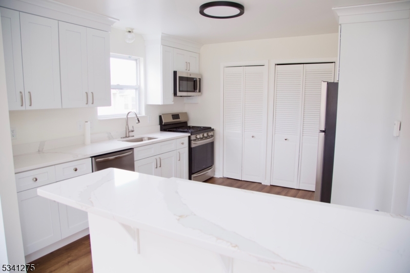 WOW FACTOR!!!!  STUNNING, TOTALLY UPDATED 2 bedroom, 2 bathroom  END UNIT at Hanover Park. This home features a gorgeous gourmet style kitchen with sleek quartz countertops and stainless-steel appliances with breakfast bar and pantry. Primary suite includes a full bathroom and two closets. Updated bathrooms provide a luxurious, modern touch, new hardwood flooring throughout, freshly painted, new a c, new furnace. Enjoy relaxing in the spacious living room, and entertaining in the formal dining room, overlooking the scenic views from the lovely balcony. Upscale living at a very affordable price! Conveniently located near major highways, shopping, restaurants, NYC trans. Enjoy this fabulous lifestyle living in this wonderful community...two assigned parking spaces, community pool, playground and plenty of visitor parking. Nothing to do but move right in and enjoy! Video coming soon.