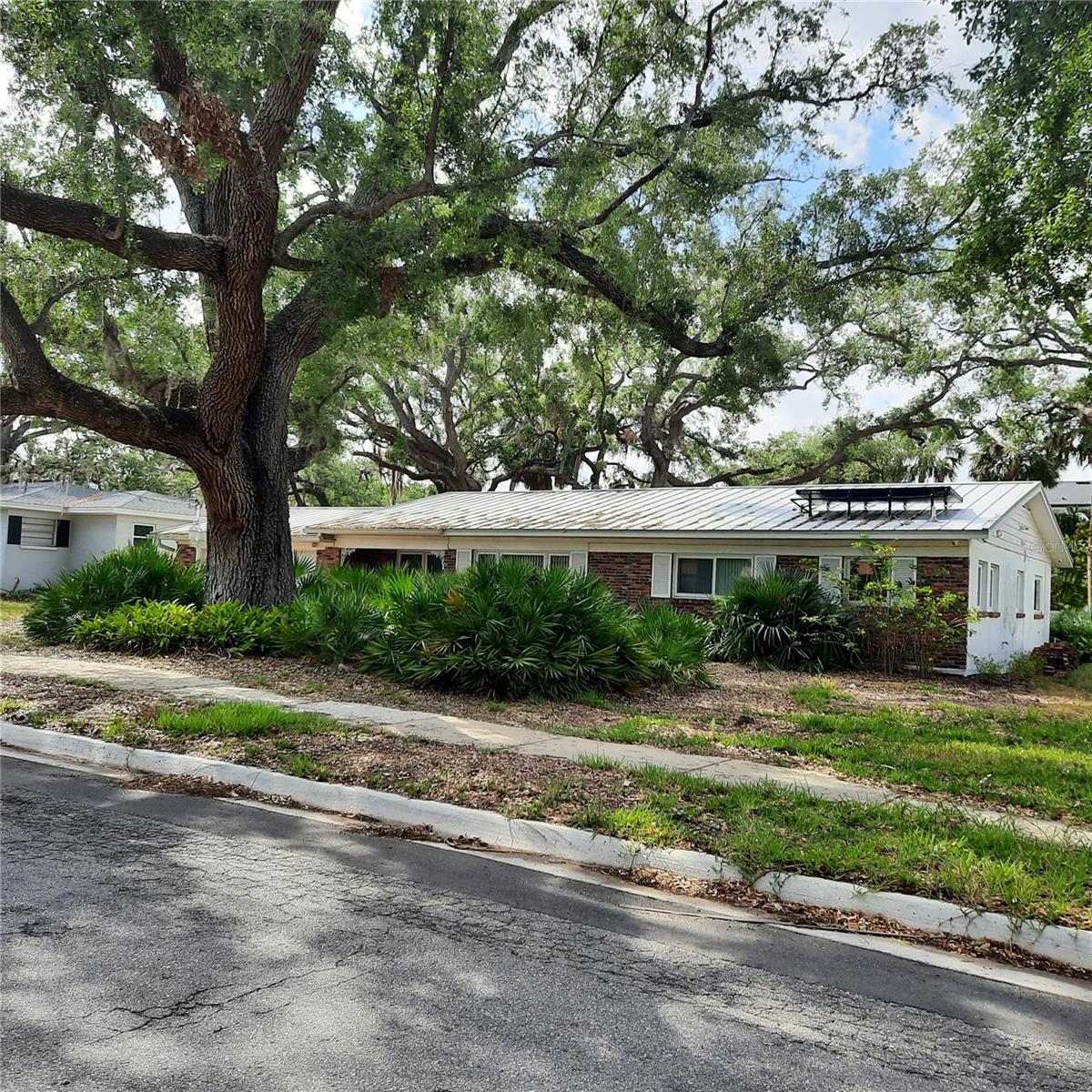 Envision the home of your dreams on this beautiful 90' wide x 138' deep lot in Sunset Park, South Tampa's most coveted location renowned for its tree-lined streets, top rated public and private schools, surrounding grand estates, and amazing convenience.  Just 6 miles to downtown Tampa, 3 miles to Tampa Airport or Bayshore Blvd, 2 miles to I-275, a short drive to Tampa General Hospital, University of Tampa, bridges to Pinellas County and its beaches, all concert and professional sports venues, and endless fine dining and shopping experiences.  The traffic light at the corner of Westshore Blvd is an added plus.  The beloved existing home was a victim of Hurricane Helene's stormwater, and while some may wish to renovate, this wide, deep lot is best suited for a new, grand, elevated home.  A newer driveway and sewer line were recently installed.  Majestic oaks are in just the right places and have been maintained by a professional arborist.  Property to be sold in "AS IS" CONDITION.  Buyer to perform due diligence.  Seller reserves the right to salvage some contents prior to closing