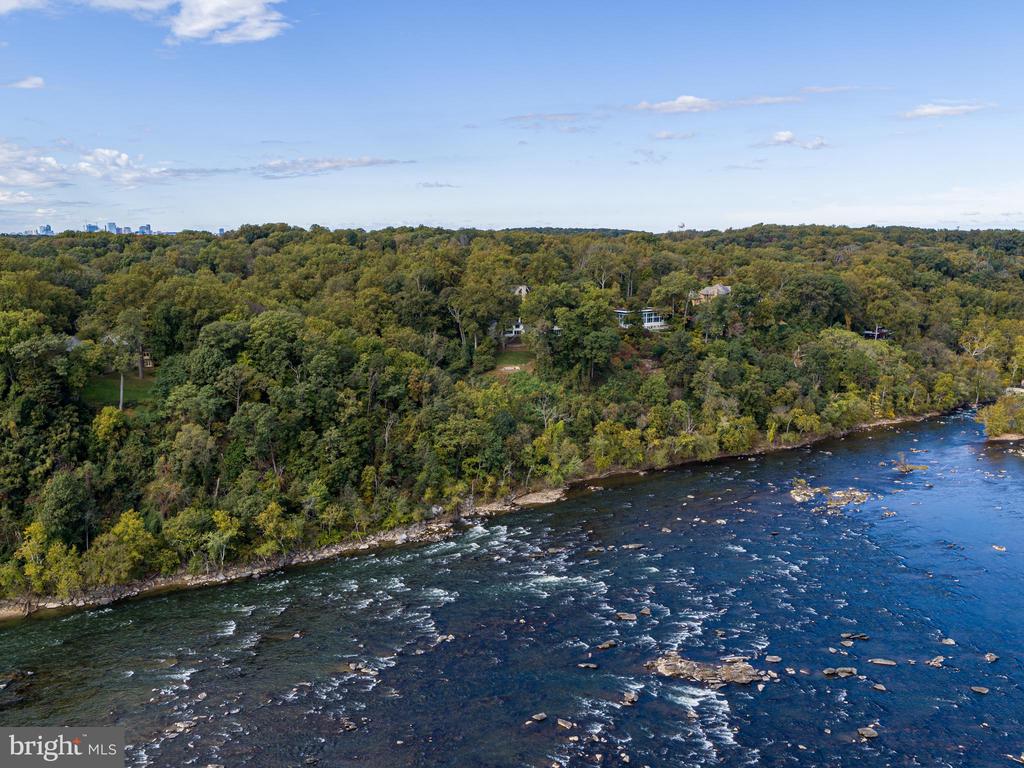 Easter Hill is the ultimate Washington riverfront estate encompassing two lots and 3.8 acres overlooking the most captivating, 270 degree views of the Potomac River. The site provides countless opportunities to create one of the region's finest estates. The existing residence provides a reference point for the opportunity which this exceptional site presents. The estate is ideally positioned on a gentle knoll which offers sweeping views in both directions along the river. In addition to the distant views, the estate affords privacy rarely available inside the Capital Beltway. The views capture the ever-changing moods of the Potomac River, providing a dynamic landscape which changes daily. Granite boulders punctuate the river in this location creating vibrant natural waterfalls and energy in the water as it flows towards the Chesapeake Bay. Abundant wildlife also seeks refuge here from the nearby city, and a wide range of Bald Eagles, Peregrine Falcons, and Red-Tailed Hawks are often visible overhead and along the water's edge. These natural wonders are clearly visible from the protected vantage point at Easter Hill. The estate is strategically located less than one mile from the District of Columbia and just over five miles to the White House. Offering extraordinary views, privacy, security, and two buildable sites, Easter Hill is the finest opportunity for a world-class estate along McLean's coveted Gold Coast.