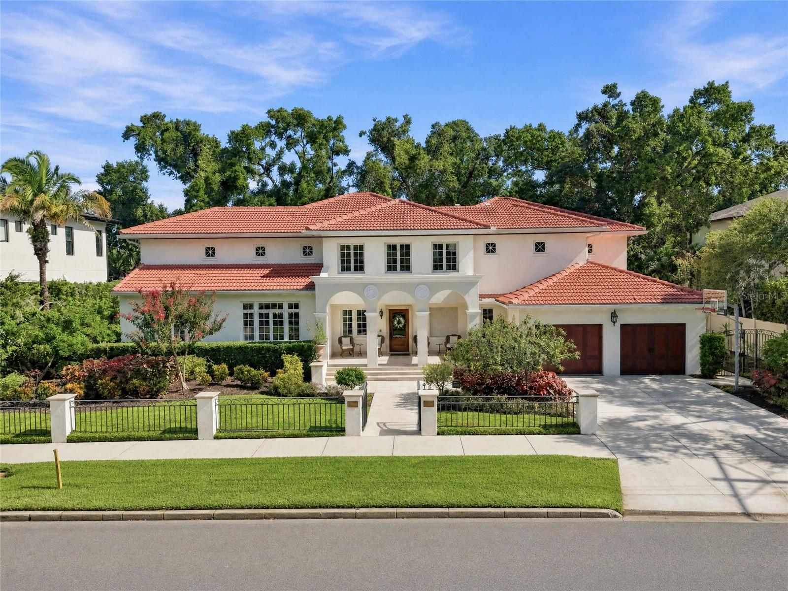 Thoughtfully crafted by renowned architect Leon Goldenberg then designer-renovated by the current owners in 2024, this light-filled Mediterranean beauty seamlessly blends timeless architectural character with modern luxuries. The extensive renovation encompassed all five bathrooms, each completely redesigned with sophisticated finishes, as well as a complete pool transformation featuring new tile and a new interior finish. Additional renovation installations included an outdoor kitchen, new air-conditioning systems, a whole-home water purification system, exterior pavers, garage doors, custom backyard playground, and numerous other enhancements.Nestled beneath majestic oak trees in desirable Beach Park, this architectural masterpiece welcomes you with an exterior front porch fountain and grand two-story foyer adorned with graceful arched hallways. Designed for both everyday living and entertaining, the expansive chef’s kitchen features premium appliances, including a Wolf range, Sub-Zero refrigerator, wine cooler, and wet bar. The kitchen flows seamlessly into the family room and sunlit breakfast nook, where walls of windows overlook the expansive backyard, complete with a new outdoor kitchen and beautifully renovated pool - a rare opportunity in Beach Park to have both an expansive backyard and pool. The poolside outdoor kitchen features an oversized grill, integrated beverage center, ice maker and stovetop burner that transitions seamlessly to the sleek lap pool. This outdoor oasis poses direct entry to the home’s downstairs private guest suite featuring a full bathroom. The oversized laundry room and mud room complete with marble floors and ample custom built-ins connect to the home’s two car garage. Upstairs offers a split-bedroom concept with Owners Retreat on its own wing featuring two separate custom built walk-in closets, large bathroom with steam shower and jets, stand alone tub and a custom vanity illuminated with LED lighting. Three additional oversized upstairs bedrooms offer walk-in closets with custom built-ins and en-suite bathrooms. Additionally, there is an adaptable upstairs retreat perfect for a children’s playroom, gym, game room or office. Ideally located within steps of idyllic Swann Circle Park and Tampa’s A+ public schools, this home is close to local shops, dining, private schools and Tampa International Airport. A rare offering that beautifully marries distinctive design with sophisticated updates, creating a home that is both timeless and effortlessly livable.
