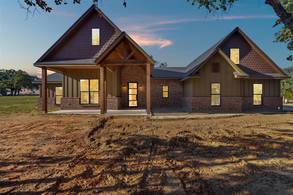 This one hits all the right notes: new construction, 2 acres with trees, and that perfect mix of rustic charm and modern design. Sitting at 2,709 square feet, this 4-bedroom, 3.5-bath home was built for comfort, space, and style.
Step inside and you’ll feel it right away. Warm tones, dark-stained cabinets, luxury vinyl plank flooring, and a floor plan that actually makes sense. The kitchen is a standout with a hidden walk-in pantry and plenty of room to cook, gather, and entertain. The living room centers around a propane fireplace insert, giving the space that cozy Texas feel year-round.
The primary suite is a true retreat with a freestanding soaking tub, walk-in shower, and all the little details that make it feel special. Upstairs, you’ll find a large bonus room complete with its own full bathroom, perfect for guests, a game room, or a private office setup.
Outside, you’ve got 2 full acres to enjoy with mature trees, open sky, and space to make it your own. It’s that hard-to-find blend of peace, privacy, and craftsmanship, all wrapped up in a beautiful rustic exterior.
This home delivers everything you want in modern country living: thoughtful design, quality finishes, and that unmistakable VYBE.