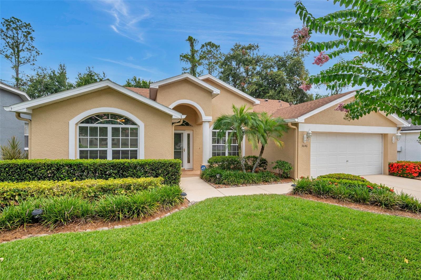 Welcome to Pinewalk—Wesley Chapel’s best-kept secret. You’d never guess this peaceful little community of just 70 homes is right off State Road 54, and once you’re in, it feels like a world of its own. All the homes here are well-kept, and this one stands out with fantastic curb appeal, thanks to its lush landscaping and two beautiful crape myrtle trees welcoming you home.
Inside, it’s clear this place has been loved. It looks and smells like a dream, and with tile floors throughout and a spotless interior, it’s safe to say Mr. and Mrs. Clean definitely live here. The kitchen and bathrooms may not be updated, but they’re so incredibly well-maintained and clean, you might just forget they’re original. The kitchen is bright and functional, with loads of wood cabinetry, Formica countertops, a closet pantry, breakfast bar, and a rolling island that stays. Natural light pours in from a wide window over the sink and an additional eyebrow window up top, and there’s also a cozy breakfast nook with views of the backyard.
The layout features vaulted ceilings throughout most of the home, adding a spacious, open feel. The front bedroom is sunny and inviting, with a walk-in closet and a double window looking out to the yard. The primary suite offers both a 5x6 walk-in closet and a second reach-in closet, an en suite bathroom with a dual vanity, jetted garden tub, and step-in shower, and even a private door (with built-in micro blinds) to the screened and covered patio. The third bedroom is tucked away at the rear of the home, with a longer-than-average reach-in closet, a backyard view, and easy access to the guest bathroom, which features a tub/shower combo and a newer premium Kohler toilet—just like the one in the primary suite.
The living room, dining area, and family room flow beautifully, and both living areas have French doors (with built-in micro blinds) that open to the spacious 12x18 screened patio. The family room features a cozy gas fireplace, perfect for a quiet night in. The laundry room is a dream for anyone who appreciates function, with upper cabinetry, a utility sink, and a window that brings in natural light. Ceiling fans keep the air moving in all three bedrooms, the family room, and the patio.
Important updates include a new roof in 2019, a new AC system with gas heat also in 2019, a gas water heater replaced in 2023, and a water softener and filtration system added in 2022. The owner also added long-lasting 25-year LED flush-mount lighting in the kitchen, living room, and family room.
The backyard is a private retreat with lush grass, a white vinyl fence (with gates on both sides), and room to relax or entertain. And with a leaded glass front door, sidelight window, and two eyebrow windows, the home is flooded with beautiful natural light all day long.
Located just minutes from top-rated schools, shopping, dining, parks, and the ever-popular Epperson Lagoon (under four miles away), and only seven miles from the Tampa Premium Outlets, this home is the definition of “hidden gem.” If you’re looking for a well-maintained, squeaky clean home in a quiet and charming neighborhood—this is the one you’ve been waiting for.