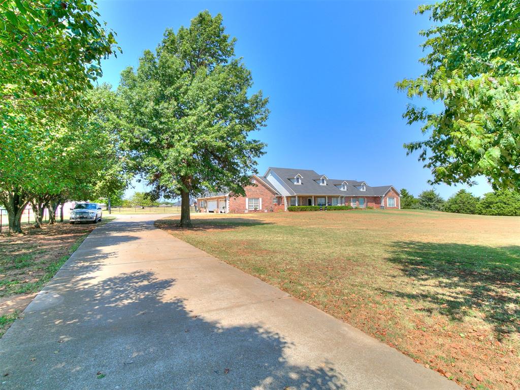 Space, privacy, and versatility come together at 5401 Castle Ridge Drive in Mustang! Situated on approximately 5 acres, this impressive property offers approximately with 5 bedrooms, 4 full baths, 2 half baths, multiple living areas, a game room, fireplaces, wet bar, and a safe room/storm shelter. The flexible layout provides plenty of room for everyday living, entertaining, guests, or multigenerational needs. Outside, the property features pipe fencing, a 3-car garage, and an approximately 40 x 60 barn/storage building offering exceptional space for equipment, hobbies, RV or boat storage, and more. Private well, septic, and add to the property's country-living appeal while still providing convenient access to Mustang and surrounding areas. Located in the Mustang School District, this is a rare opportunity to enjoy acreage, substantial living space, and an oversized outbuilding without giving up a convenient location.