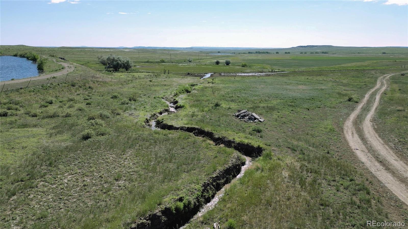 Located on the southern periphery of Walsenburg, Colorado, the Bell S Spanish Peaks Ranch offers a multitude of possibilities to the discerning buyer. The ranch spans 6,865 deeded acres (+/-) and is afforded ease of access from frontage roads that parallel Interstate 25. The Bell S is perimeter and cross fenced into (9) pastures ranging from 321 to 975-acres. In addition, the ranch contains approximately 110-acres of irrigated crop currently planted in an alfalfa/bromegrass mix and sorghum. Annual hay production for 2024 is forecasted at 1.5-tons per acre. The ranch has grazed between 475 and 525 yearlings for the last three years (Mid-May through September), while resting 2 to 3 of the pastures. It is estimated that the ranch could handle up to 700+ yearlings over the same period assuming average annual precipitation. Two gallery wells distribute water to (12) above ground stock tanks dispersed throughout the individual pastures. Well number (1) is electric powered with a dedicated meter, while well number (2) was recently upgraded to solar.  There are also several dirt tanks and ponds that gather seasonal rain fall and run-off. The ranch contains senior water rights originating from the Cucharas River. Existing improvements are grain bins, a Quonset building and a recently updated set of working pens. The ranch is afforded panoramic views to the west that include the Spanish Peaks, Sangre De Cristo and Wet Mountains. A sizable arroyo extends through the central portion of the ranch that serves as both a wildlife corridor and shelter for the livestock. Pronghorn and mule deer are common inhabitants with the occasional sighting of elk. The direct frontage and visibility along Interstate 25 presents the possibility of future commercial development. Wind, solar, or conservation easement are all possible uses. The town of Walsenburg and its amenities are a short 5 minute drive for the ranch.