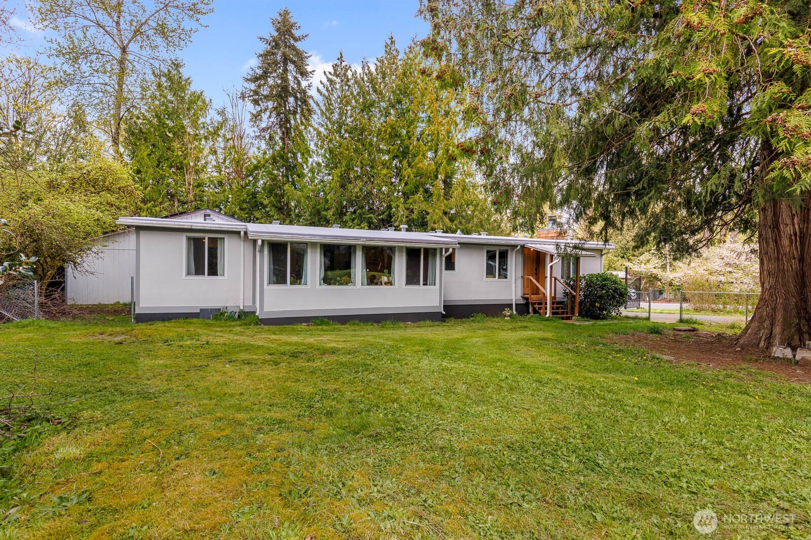Opportunity meets versatility on this spacious, level corner lot just minutes from downtown Renton and I-405. Tucked into a quiet no-through-road neighborhood, the property strikes a rare balance of privacy, convenience, and future potential. The updated 3-bedroom, 2-bath home has been refreshed throughout with new flooring, fresh interior and exterior paint, stylishly renovated bathrooms with quartz cabinetry, custom solid wood doors, and a built-in closet system. Behind the finishes, the big-ticket items are already done: a brand-new HVAC system with mini split, smart thermostat, updated electrical panel, new lighting throughout, brand-new roof, newer siding, and recently installed crawl space and blown-in insulation. Energy-efficient solar panels, a water filtration system, and appliances round out the package, along with smart home features including app-connected locks and exterior lighting. Outside is where this one truly stands apart. An impressive newer 2-car garage offers three fully powered workshop spaces, ideal for hobbies, business use, or extra storage, and is joined by a large shop, a shed, multiple potential RV hookups with water access, an EV charger, and a custom security gate for added privacy. The expansive lot leaves room to expand, build, garden, or simply enjoy the space. A rare find with flexibility, upgrades, and room to grow. Don't miss it! Does not qualify for conventional, VA or FHA financing.
