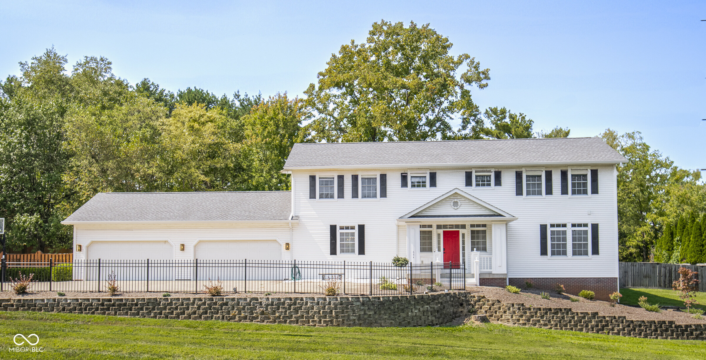 Welcome to this exceptional 6-bedroom, 5.5-bath home situated on .75 acres and just 2 miles from the IU campus. With over 4144 square feet, this home offers multiple living/gathering areas and versatility to meet the needs of today's busy households. Step into the heart of the home-a beautifully updated kitchen featuring sleek finishes, a spacious walk-in pantry, and ample prep space for the avid cook. New luxury vinyl plank flooring flows throughout much of the home, combining durability with a modern aesthetic. Upstairs, you'll find generously sized bedrooms, each with its own ensuite full bath, a newly created office with a walk-in closet which adds flexibility for working from home, studying, or extra storage., and large family room with gas log fireplace and theater equipment. Enjoy practical amenities like two laundry areas, a hot tub hookup on the back patio, and a fully fenced backyard complete with a built-in playset and brick firepit-perfect for outdoor gatherings year-round. The 4-car attached garage offers ample space, with the first 2 bays heated and both garages outfitted with extra shelving for convenient storage. Major upgrades include a new roof in 2024, ensuring peace of mind for years to come.    Don't miss the chance to own this beautifully maintained and move-in ready home that truly has it all!