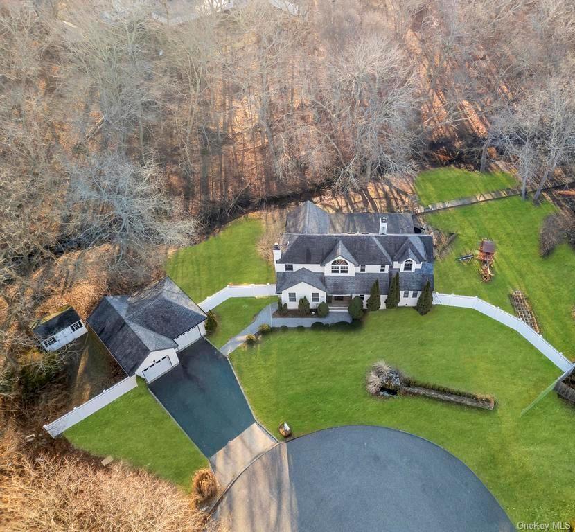 Welcome to this Stunning Young Colonial Which Offers Scenic Creek Views, a Private Dock and Access to Crystal Beach on over 3/4 of an Acre! Step into a Dramatic 2 Story Entrance Foyer with Cathedral Ceilings and Open Floorplan Enjoy a Living Room with a Cozy Gas Fireplace, Flowing Seamlessly into a Large Formal Dining Area (that can seat up to 10 Guests) and Updated Kitchen, Equipped with Granite Countertops, Stainless Steel Appliances, Gas Cooking. Enjoy a First Floor Primary Suite with a Gas Fireplace, Perfect for Winter Nights, Walk in Closet, Full Bath Featuring a Soaking Tub, Stand-up Shower, and Double Vanity. A Peaceful Retreat with Sliding Glass Doors Leads Outdoors, Perfect for Morning Coffee. An Updated Half Bath and MudRoom with Utilities Complete the First Floor. Head Upstairs Offers 3 Bedrooms, a Full Bathroom, and an Open Hallway Overlooking the Foyer Below. A Detached 2- Car Garage has Been Partially Converted to Living Space, Offering Potential for Add't Living/ Office Space or Rental Potential with Proper Permits. Updates and Amenities include: Hardwood Floors throughout Most of the Home, Anderson Windows, 200 Amp Electric, New Wood Deck (Approx 3 Years Old), 2 Zone Heat and AC, One AC Condenser from 2017, Crown Molding and Recessed Lighting. Close to LIRR, Great for Commuting and Enjoy Membership with Crystal Beach Owners Association-featuring Marina Beach, Boat Slips, Picnic Spot and Private Community Events. Don’t miss this opportunity to own a truly special waterfront retreat.