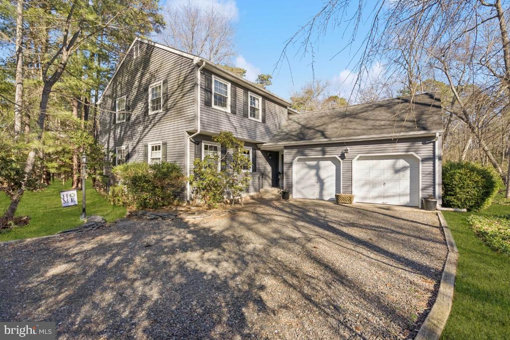 OPEN HOUSES!  SAT MARCH 14 1-3 AND SUN MARCH 15 12-2!  Come home to Lake Pine! Four bedroom 2 1/2 bath colonial on a cul-de-sac nestled in the pines on a naturalized lot backing to woods. Featuring an updated kitchen with granite countertops, dining room, inviting step-down family room with wood stove, large bright living room and bonus room (converted garage bay). Enjoy the beauty of nature from the screened porch and back deck.  First floor is completed with a welcoming foyer, laundry room and powder room. Upstairs offers primary bedroom with walk-in closet and large wall closet, primary bath offers stall shower. Additional bedrooms are nicely sized with loads of closet space.  All closets have closet organizers. Roof, siding and windows were replaced in 2009; On-demand water heater installed in 2011; AC is 18 years old and gas furnace is 10 years old. Enjoy all the amenities and social offerings of a lake community! Whether it's pickleball, book club or lounging at the beach, Lake Pine has something for everyone.