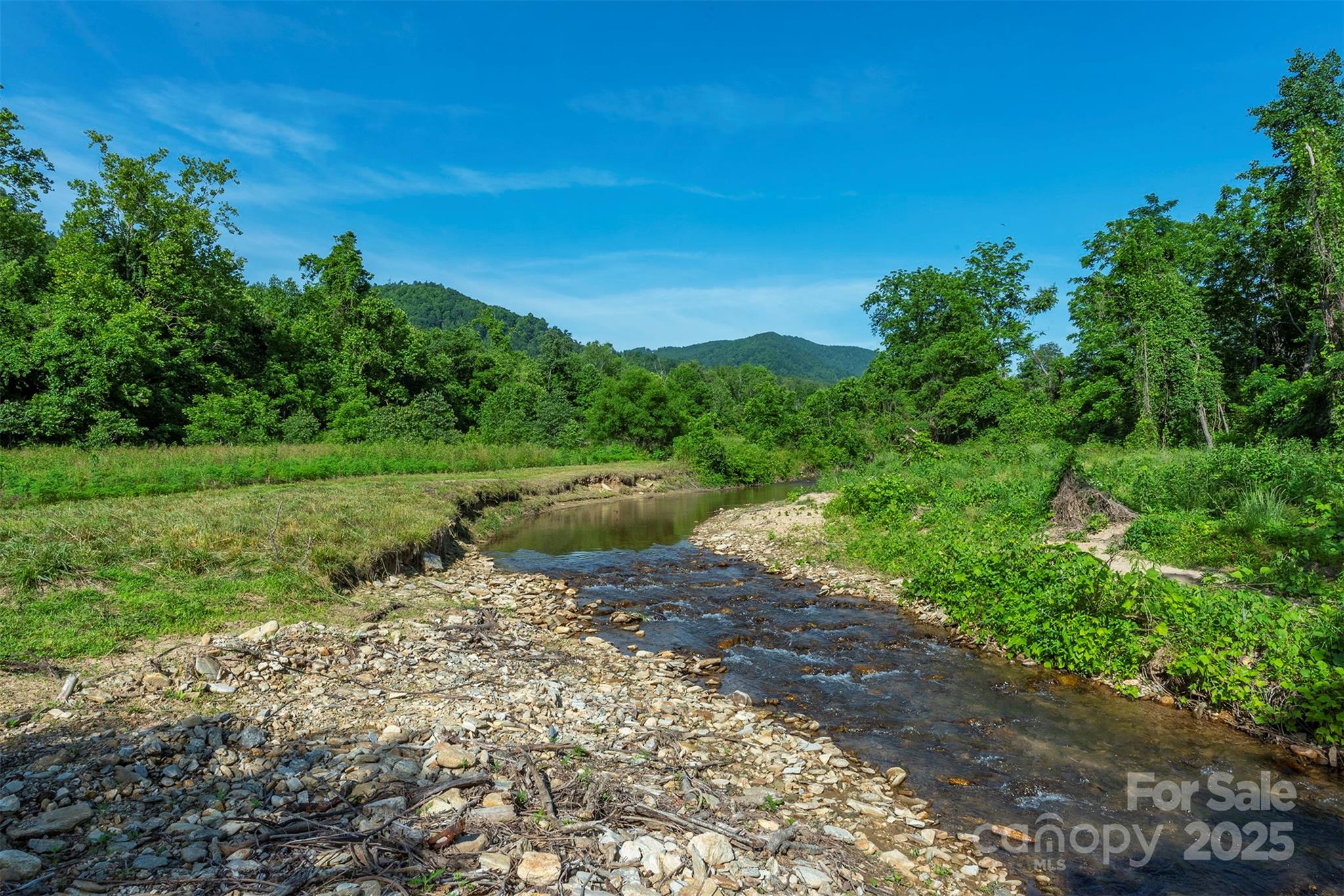 Less than ten minutes from I-40 and downtown Old Fort, sits a rare hidden gem. This 112-acre property starts with 2200 feet of frontage on the Crooked Creek basin and climbs from the level valley bottom, stair-stepping up to a mountain Ridgeline. This historic farm features several grassed pastures, a forest rich in diversity, three houses, a historic barn, and several other outbuildings. Each structure requires your touch, but the potential is endless. Step back in time with the historic farm house, or finish out the one-room cabin or two-story house located halfway up the property. There are over two miles of rough farm road easily accessible with a 4 wheel drive vehicle. Listing agents are happy to meet you there to show you around with proper notice. No matter what your goal is, farm, family compound, recreational land, horses, this property has what you are looking for. New bridge and grading has made access easier, but 4WD is still recoomended for interior roads on the property.