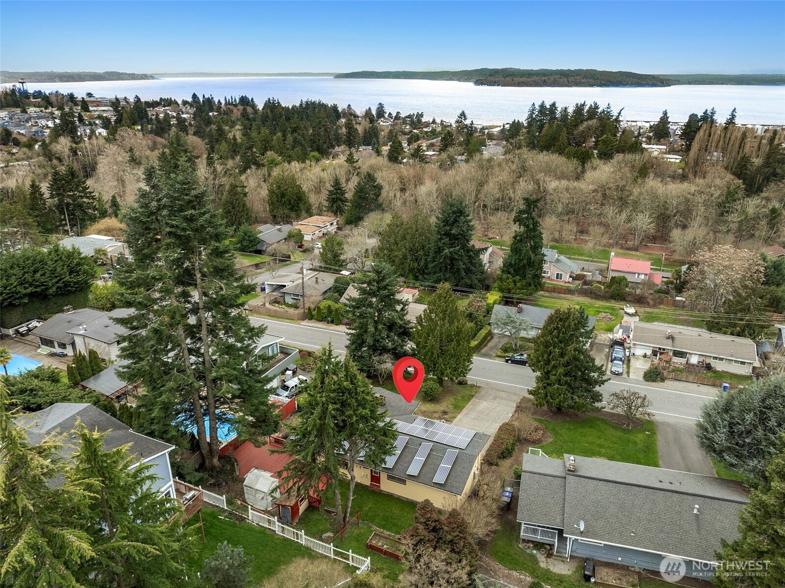 Experience the perfect blend of coastal charm and modern efficiency in this meticulously maintained Des Moines gem. Boasting peak views of the Puget Sound and Olympic Mountains, this home shines with restored hardwoods and a fully remodeled kitchen and baths. The main floor features an airy, open-concept living space with a gas fireplace and a primary suite complete with a spa-like shower. Downstairs, the finished lower level offers a large recreation room, office nook, 3/4 bath, and an additional flexible room—perfect for guests or a hobby space. Sustainable living is easy here, thanks to 33 solar panels and a newer electrical panel. Outdoors, the wrap-around entertainment deck is hot-tub ready and ideal for sunset views, while the property also features RV/boat parking, raised garden beds, and a wood shed. With a filtered water system and a recently renovated utility room, every detail has been thoughtfully updated for modern comfort. This turnkey residence offers more than just a home; it’s a meticulously crafted retreat designed for both relaxation and functionality.