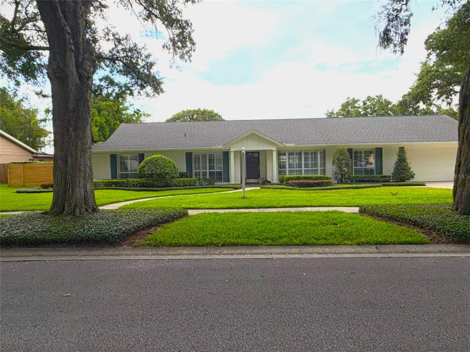 New Price!! Beautifully updated pool home in the sought-after King's Row, Maitland community. This home blends timeless character with modern finishes. The corner lot residence features a three wide driveway, freshly updated landscaping and a commercial grade in ground basketball goal. Exterior paint (2026) creates warm curb appeal. Inside, new wood floors throughout lead to an open living space anchored by an updated kitchen and a classic painted brick wall. The renovated kitchen features quartz countertops, custom cabinetry, pendent lighting, stainless appliances and an updated Fisher Paykel refrigerator. A large island provides seating for four makes entertaining quick and simple. An updated hall pool bath provides easy access for guests both inside and out. Steps away the multi tasked laundry/utility drop/zone is conveniently located off the rear double garage entrance. A commercial grade Speed Queen washer in the laundry/utility room assures your clothes will be clean. Also, an adjacent wall of cabinetry increases the incredible storage in the home. Not only in the front but in the back the corner lot offers an ample spaced backyard retreat. Added is a screened and covered lanai perfect for outdoor parties and gatherings as does the oversized in-ground pool. Zoysia grass/lush landscaping and lighting continue the resort feel. A newer, horizontal stained wood fence adds privacy while maintaining charm. Back inside the living room, a rattan light fixture adds to the ambiance of this bright natural light space. Next to the living space, an office that features a set of French doors lends a place for quiet conversation. The generously sized family room with the afore mentioned painted brick wall is complete with large windows overlooking the sparkling pool and views of three whimsical palms. Down the hallway the newly installed designer wood flooring continues to all bedrooms. Every bedroom just received fresh paint, as well as the newly installed wood floors. All closets feature custom built-ins that add to the level of sophistication/quality in this home. The primary bedroom features another custom painted brick wall with updated sconce lighting. Still another set of French doors lead out to the pool and lanai. The owner's bath features a double vanity with stone counter-tops and updated lighting and faucets. A Mitered frameless glass shower is a great addition to the richness of the space. Zoned for Dommerich Elementary, Maitland Middle, Ninth Grade Center and Winter Park High the schools are highly desirable.  A quick and easy close can be the start of your next chapter. This Move-in ready home awaits......