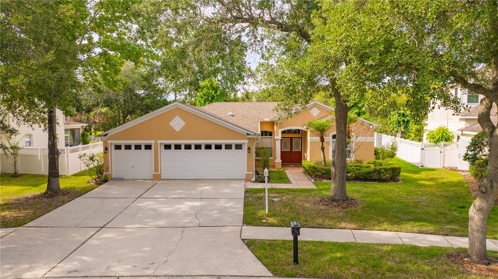 One or more photo(s) has been virtually staged. Welcome to this BRIGHT and SPACIOUS 4-bedroom, 3-bathroom home with a 3-car garage located in the highly desirable Tampa Palms community! From the moment you arrive, you’ll appreciate the grand double-door entry and the peaceful charm of the neighborhood.Step inside to a bright and open floor plan featuring a spacious formal living room and dining room, perfect for family gatherings and entertaining. The three-way split layout offers privacy and comfort for everyone.The large family room opens to the kitchen, creating a wonderful space to spend time together. The kitchen features granite countertops, stainless steel appliances, and plenty of cabinet and counter space.The primary suite is privately located on one side of the home and offers direct access to the screened patio. The primary bathroom includes dual granite vanities and a relaxing Jacuzzi jetted tub.On the opposite side of the home, you will find the additional bedrooms, including one bedroom with its own private bathroom—perfect for guests, a teenager, or family members who need extra privacy. The other two bedrooms share a separate full bathroom.The laundry room includes a utility sink and extra cabinets for storage. The oversized 3-car garage and extended driveway provide plenty of room for parking and storage.Enjoy Florida living in the large screened back patio with a gazebo canopy and its own TV. The   spacious backyard features mature trees, a peaceful water view, and sits on an oversized lot of more than a quarter acre, offering privacy and plenty of room to enjoy the outdoors.Conveniently located with easy access to Bruce B. Downs Boulevard and I-75, and just minutes from USF, Moffitt, USAA, hospitals, top-rated schools, restaurants, shopping, and entertainment.Don’t miss your chance to see this wonderful Tampa Palms home!! Schedule your private showing today!