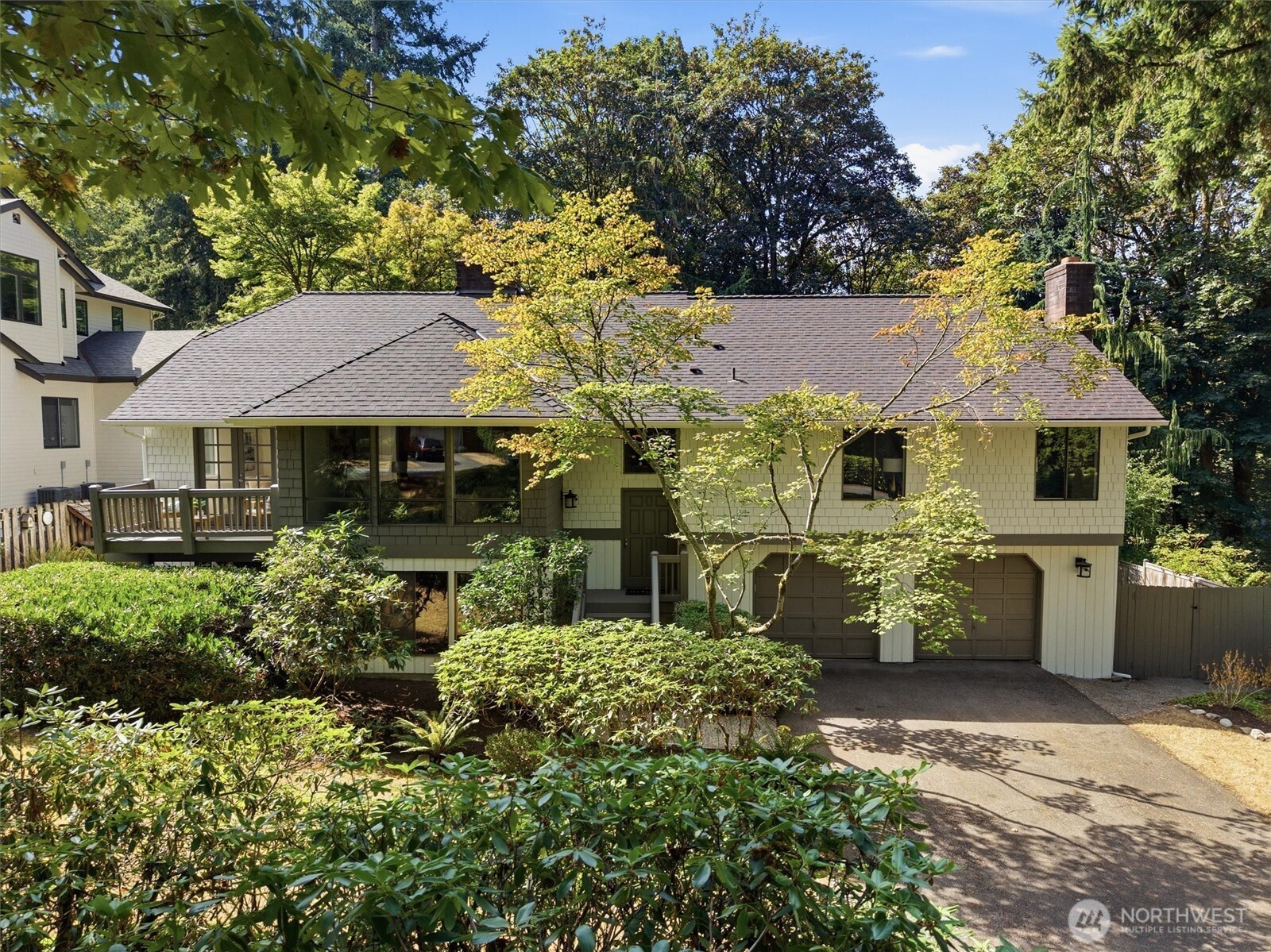 Welcome to a rare offering in Redmond's highly desirable Cascade View Park neighborhood, just steps from Microsoft's main campus. Tucked away on a quiet, private lane, this legacy property sits on 1.67 acres, offering a level of privacy and space seldom found this close to the city's core. The lot backs to a peaceful greenbelt featuring privately owned wooded trails in a secluded, nature filled setting, just minutes from everything Redmond and the greater Eastside have to offer. The home itself spans 2,960 square feet with 5 bedrooms and 3 baths, and has been thoughtfully maintained over the years. Inside, you'll find multiple fireplaces for warmth and character throughout, a finished basement with ample living space, and a basement garage for convenient parking. A deck off the main living area invites you to take in the surrounding greenery and quiet of the lot. Location is everything here, with a short stroll to Microsoft's main campus and notably, a short walk to the Redmond Technology light rail station. The location offers easy access in any direction to Highway 520, Lake Sammamish, Idylwood Park and Marymoor Park. Shopping, dining, and entertainment are all just minutes away, and the home falls within the award winning Lake Washington School District. Secluded and peaceful, yet unbeatably located, this is a rare combination on a lot this size, in a neighborhood this established. A true standout opportunity you won't want to miss.
