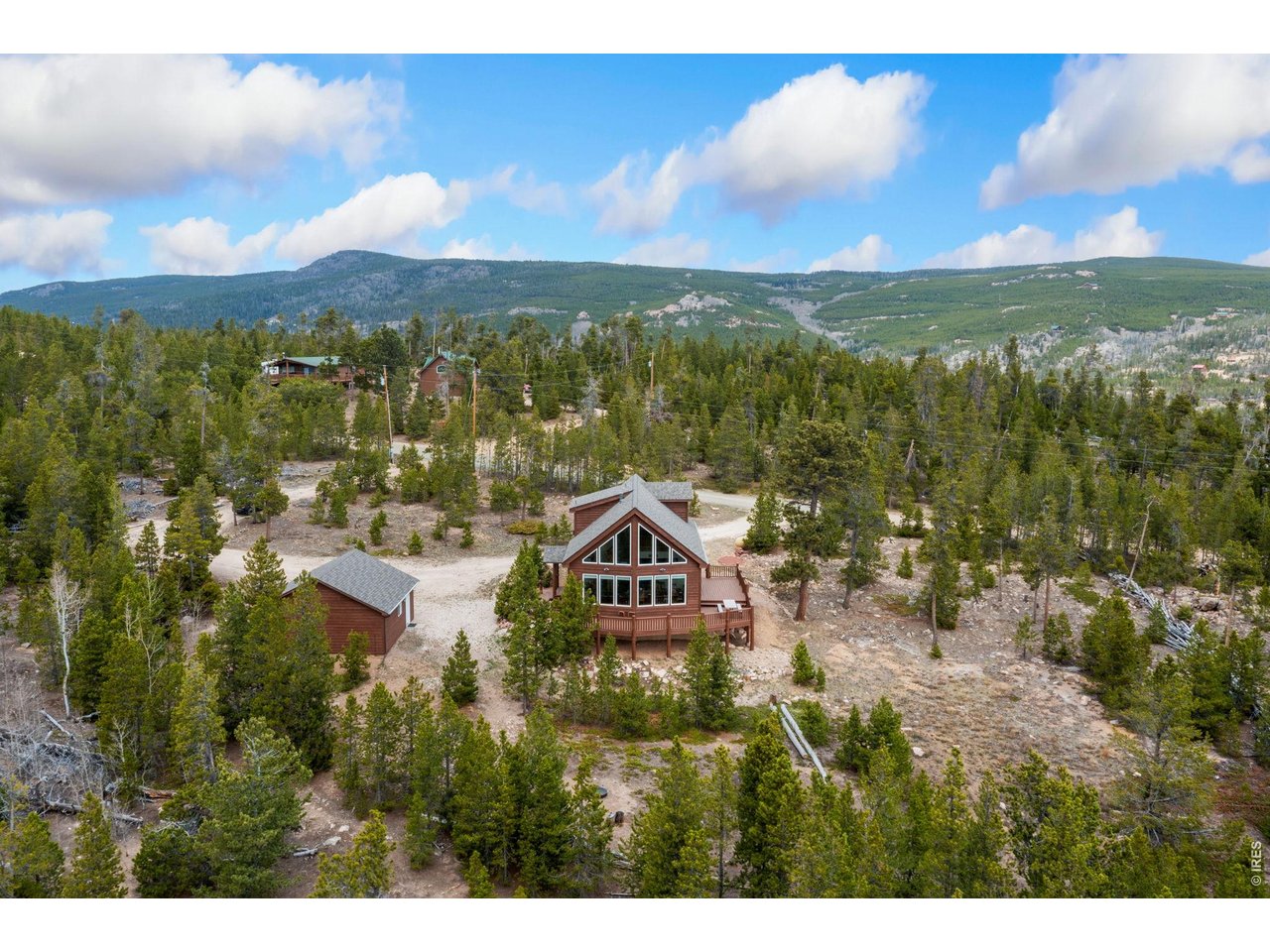Experience the best of Colorado living with this exceptional home that sits on 1.33 private acres. Offering a rare blend of space and serenity, this home features 3 bedrooms, 2 bathrooms with a two car detached garage and sweeping mountain views from nearly every angle. Wake up to majestic mountains -where big skies stretch endlessly and sunrises feels like a private show.This warm and inviting home has been thoughtfully upgraded for comfort and efficiency, featuring a new Class 4 roof, stainless steel appliances, and enjoy peace of mind with a Kohler whole-house backup generator and your own private water well source. Enjoy outdoor dining on the fabulous deck as the sun sets over the mountains or take in the star filled skies in the privacy of your own oasis. Gather with family and friends around the outside firepit and enjoy the beautiful calm the Colorado mountains provide.Located in the Crystal Lakes community, you will enjoy private and exclusive access to:Fishing in private association waters and the North Fork of the Poudre River, plus over 65 miles of community trails with adjacent National Forest access. Hiking and kayaking are a peaceful way to enjoy your day. Benefit from year-round road maintenance and plowing, and your own private well water.Just a few miles from the Village of Red Feather Lakes and an easy 90-minute drive from Loveland/Fort Collins with no interstate travel required. The Village of Red Feather Lakes offers dining, a small grocery stores, a post office, library, hardware store, and fun community events throughout the year. Welcome home to your mountain sanctuary surrounded by breathtaking beauty and brimming with wide-open spaces, forever views and endless recreating possibilities that create the freedom to live the lifestyle you've been dreaming of. Your own slice of paradise! This is a turnkey home as the Sellers would like to leave all furnishings, artwork and decor. Welcome home!