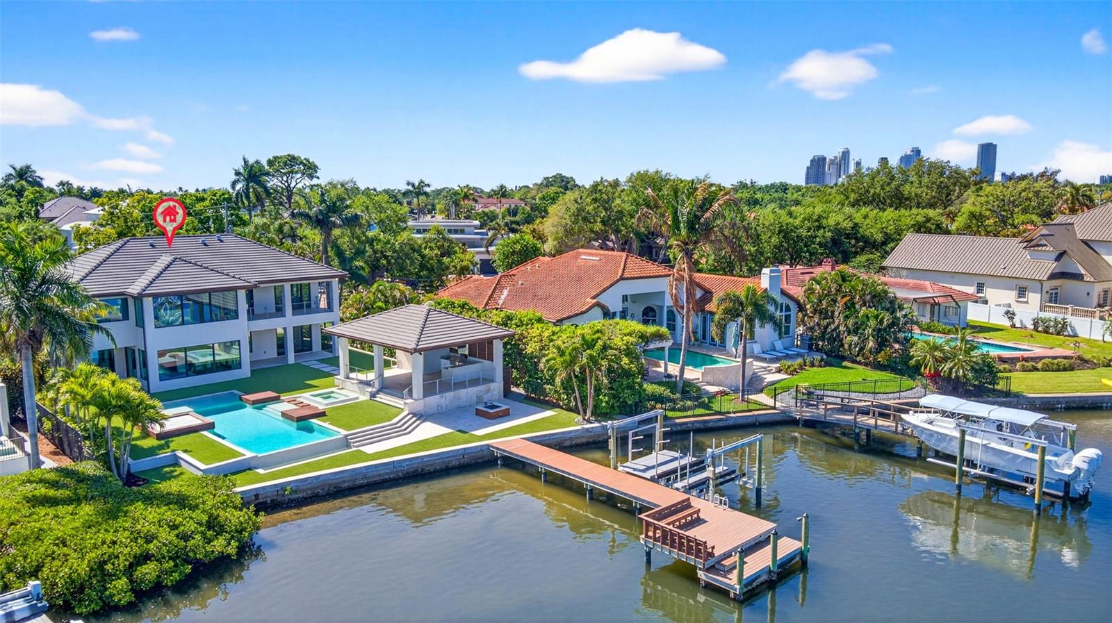 One or more photo(s) has been virtually staged. A striking expression of contemporary design and resort style living can be your own private oasis. A truly exceptional waterfront residence that has undergone two major renovations. Completely rebuilt in 2018 by Bright Bay Construction and further enhanced with a full first-floor renovation in 2026 with design assistance by Michael Masty and Haven Design. Over 5,300 square feet of Clean architectural lines, curated finishes, and seamless indoor-outdoor flow create a sophisticated yet relaxed residence designed for both everyday living and elevated entertaining. Ideally positioned on a quiet cul-de-sac in the coveted Coffee Pot Riviera of Snell Isle. This home is walking distance to the private Vinoy Golf Course and vibrant downtown St. Petersburg. The floor plan was thoughtfully designed to balance function and elegance. Featuring four bedrooms, a dedicated office, media room, and four full and two half well-appointed baths. The primary suite is a true retreat, showcasing expansive water views and a serene, spa-like ambiance, complete with a showstopping closet sure to impress any fashion enthusiast.At the heart of the home is a stunning designer kitchen, appointed with high-end finishes, top-of-the-line appliances, a custom-built-in dining table.  Artfully designed glass-enclosed wine cellar serves as a striking focal point. The living area is anchored by a sleek linear fireplace, creating a warm yet modern centerpiece. The home office features elegant cove ceilings, offering a refined and inspiring workspace. The media room is complete with a convenient half bath, providing the perfect setting for movie nights or game-day gatherings. Step outside to a true resort-style experience. A covered outdoor kitchen and full pool bath complement the beautifully designed pool area, featuring cabana-style living with daybeds—ideal for relaxing or hosting guests. Lush turf and professionally curated landscaping enhance the property, creating a low-maintenance yet vibrant Florida oasis. Large new dock with 2 new lifts, one ready for your boat, the other with decking to make launching your paddleboards or kayaks a breeze.  The backyard will be your tranquil retreat where you can enjoy daily sightings of manatees and dolphins. For added peace of mind and long-term protection, the home is equipped with installed water dams, preserving the integrity of this exceptional property. The home also features a whole-home generator. Blending impeccable design, luxurious amenities, and an unbeatable waterfront lifestyle, this residence represents a rare offering in one of St. Petersburg’s most desirable neighborhoods.