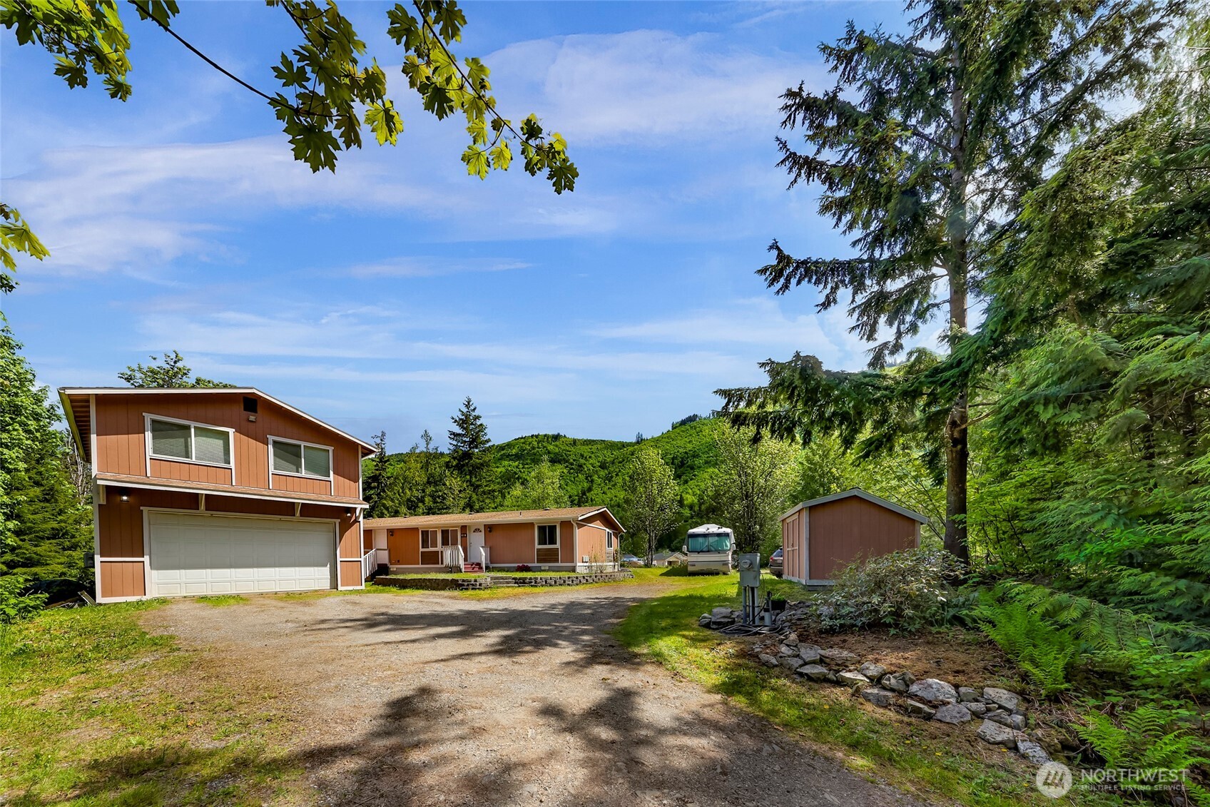 Looking for a single level, turn-key home on acreage w/ shop + ADU potential? This property has it all! Blending modern comforts w/ rural charm, this pre-inspected home offers affordable living & a great rental income opportunity. Serviced w/ public water & sewer plus no HOA restrictions! Upgrades incld: triple pane windows, engineered HW, exterior siding, AC & gourmet kitchen. Outbuildings & RV parking w/ sewer clean out. The 22'x30' shop is insulated w/ attic fan, 50 amp panel & inclds 550 sqft finished bonus space for potential ADU. Water & sewer lines run adjacent to shop to easily add a bathroom. Enjoy the privacy of 4.5 peaceful wooded acres w/ 30+ year established timber & views of Red Mountain & the North Cascades as your backdrop!