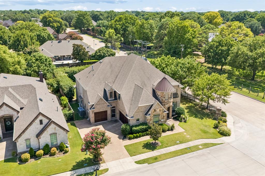 This beautiful two-story brick and stone home offers plenty of space for a growing family in a peaceful, upscale neighborhood. The bright and open floor plan features high ceilings, rich wood floors, and large windows that fill the rooms with natural light.The heart of the home is a spacious kitchen equipped with a large island, granite countertops, and built-in appliances, making it easy to cook and entertain. It flows right into a comfortable living room with a cozy fireplace, perfect for family time. With five large bedrooms and four full bathrooms, everyone has their own private space. Upstairs, the home opens up into a spacious game room that leads directly into an incredible media room complete with a built-in snack bar, making the entire second level the ultimate spot for family movie nights and weekend fun.Outside, the large covered patio is perfect for barbecues and relaxing. The private backyard features a cozy built-in fire pit for evening gatherings and plenty of room to build a custom pool. A built-in sprinkler system keeps the grass green with very little effort. The property also includes a spacious three-car garage with tons of extra storage. Located just down the street from an elementary school and inside an excellent school district, this home is perfect for a convenient, comfortable lifestyle. Best of all, it sits just minutes away from Highway 121, premier local shopping, a wide variety of restaurants, and the exciting new H-E-B Mid-Cities store.