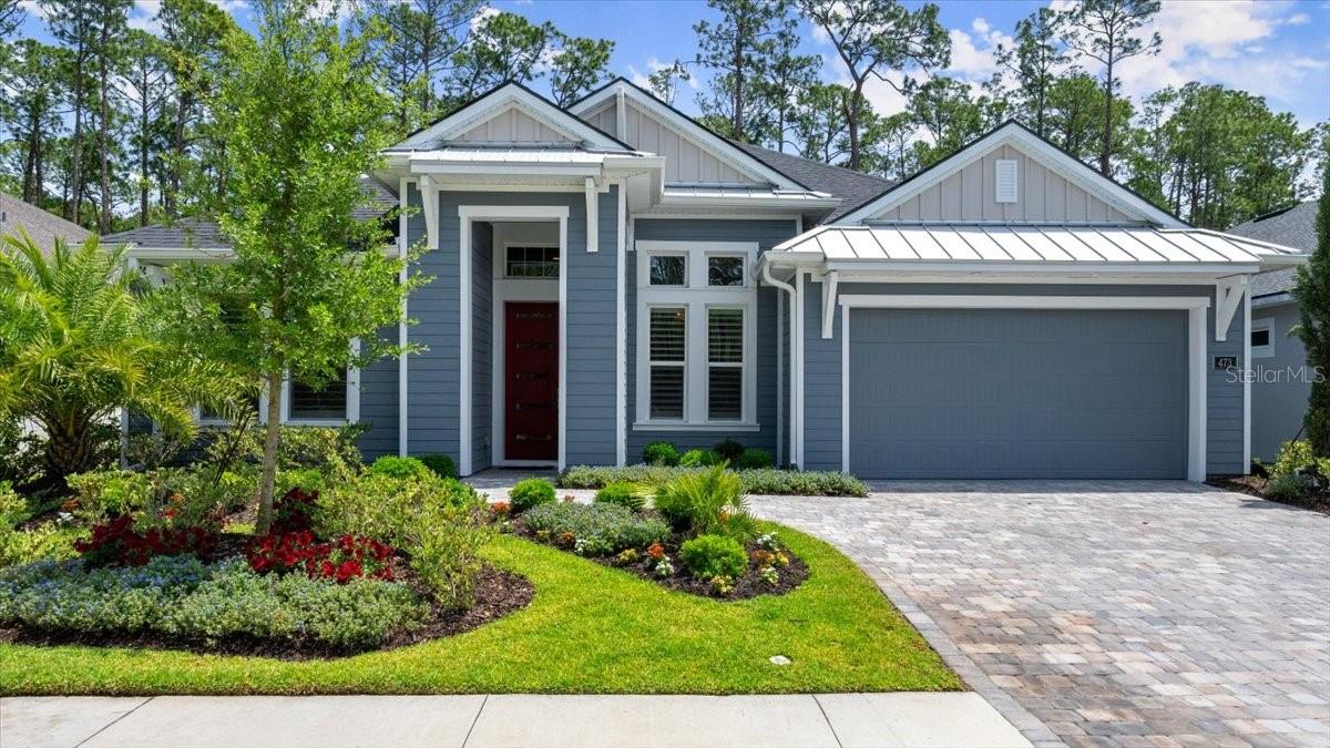 One or more photo(s) has been virtually staged. Welcome to 473 Stirling Bridge Dr, a stunning home that combines elegance and functionality in every detail. As you enter through the custom door with glass inserts, you're greeted by wood floors and soaring high ceilings that create a sense of grandeur. The family room is a perfect blend of comfort and style, featuring wood floors, tray ceiling with crown molding, & sliders that lead to a beautiful lanai. The formal dining room is an entertainer's dream, boasting wood floors, a casual crystal chandelier, and custom window treatments. The oversized kitchen is a chef's delight, equipped with a gas range, GE Profile stainless steel appliances, two-tone cabinetry, and 42-inch all-wood cabinets with soft-close features. The kitchen is further enhanced by a travertine stone backsplash and a quartz countertop island with a drop edge. Hidden pantry feature perfect for all your cooking needs. Retreat to the master bedroom, where upgraded carpeting and a tray ceiling complement the large windows showcasing a serene preserve view. The master bathroom offers a luxurious experience with a long quartz vanity, dual sinks, a walk-in shower with herringbone stone tile, and a walk-in closet with custom built-ins. Bedrooms 2 and 3 feature wood flooring, plantation shutters, and custom wood shelving, providing ample storage and natural light. Bathroom 2 is elegantly appointed with quartz countertops and custom tile work. The office/flex room, anchored at front of home, with its wood flooring and plantation shutters, offers a versatile space for work or relaxation. Bedroom 4 is it's own retreat with wood floors and right off Bathroom 3-finished with tile, walk-in shower and quartz countertop. Walk through your vanishing sliders to the travertine extended lanai pre-plumbed for an outdoor kitchen. The crystal blue, saltwater pool with a fountain accent and deep preserve view provides a tranquil escape, with plenty of room for pets to roam. The home also includes a three-car garage with epoxy floors, a hybrid hot water heater, and a convenient stop-and-drop area. Outdoors, enjoy lush landscaping with vibrant florals, a paver driveway and walkway. Optional memberships available varying from 45 holes of golf, 10 pickle ball courts, 10 tennis courts, brand new 30-million-dollar Founders Club, fitness/spa center, full fitness class calendar, resort style pool along with lap pool and cabana bar & Grill, additional Prestwick clubhouse, bocce ball, and so much more. Buyers of this home to receive a substantial discount on initiation fee at the club. Ask listing agent for details. This exquisite home is equipped with abundance of upgrades including a Google Nest thermostat, comfort height Kohler toilets throughout, wood floors throughout, soaring ceilings with crown molding, hardy board plank siding and metal roof accents for coastal elevation, Minka fans and custom light fixtures throughout, custom mirrors in bathrooms, custom herringbone tile through master bath shower, great natural light, widened driveway for convenience, preserve views across the street for natural surroundings, wood shelving throughout, plus much more! Experience the perfect blend of luxury and practicality in this coastal masterpiece. With its thoughtful design, modern amenities, and breathtaking surroundings, 473 Stirling Bridge Dr is more than just a home, it's a lifestyle. Seize the chance to own this exceptional property and create lasting memories in a setting that truly stands apart.