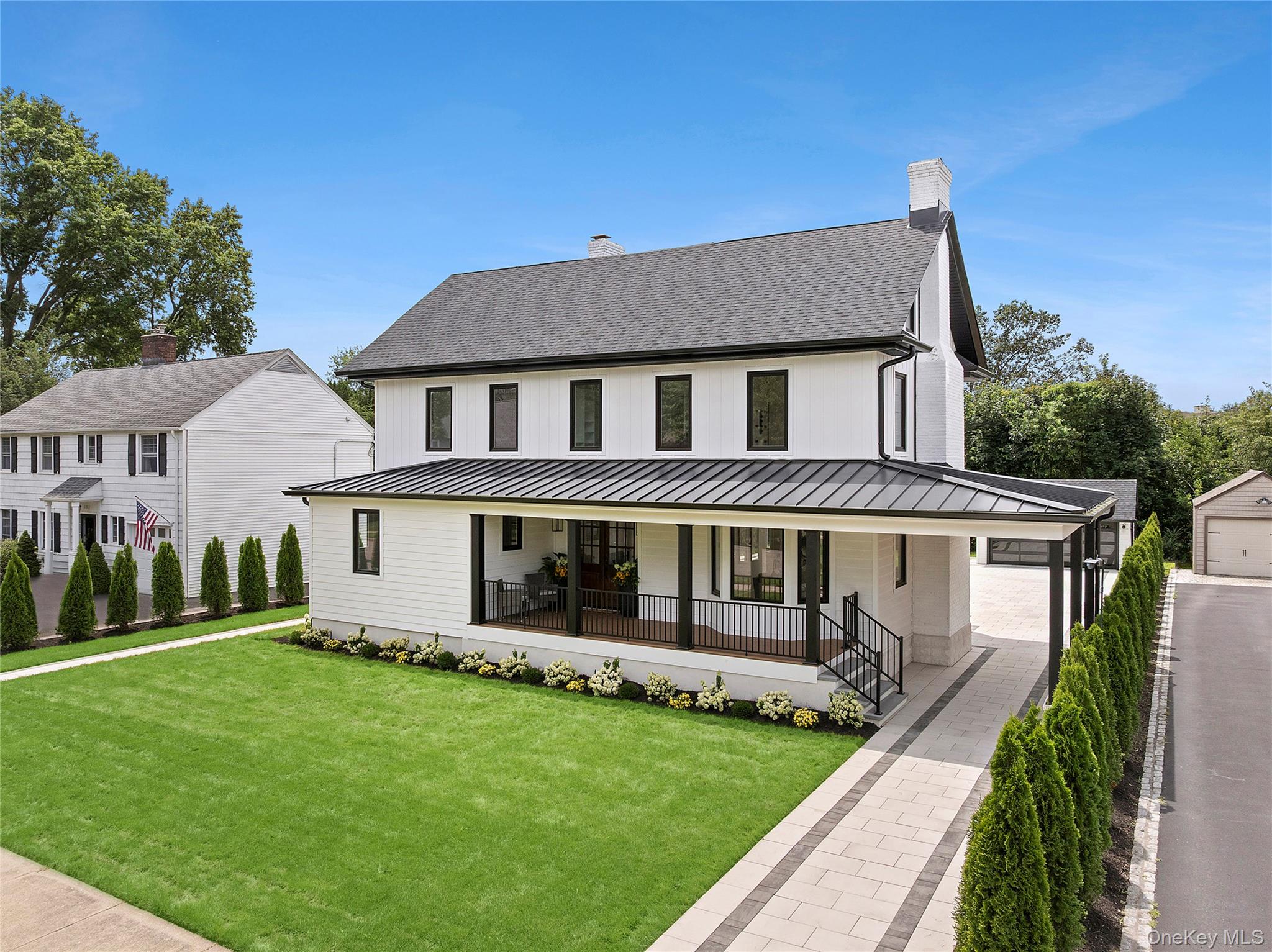 This magnificent five-bedroom, four-bathroom Garden City Colonial was completely rebuilt in 2024. Situated on a picturesque tree-lined street in the heart of Garden City's Central Section, this stunning new construction has been thoughtfully and thoroughly designed with the highest quality finishes and an unwavering attention to detail—offering refined living with modern functionality.A covered front porch with clean architectural lines opens to a grand entry foyer, where 10-foot ceilings and 10-inch wide-plank white oak hardwood floors set the tone for elevated design and extraordinary craftsmanship throughout.On the first floor, the formal living and dining rooms are adorned with coffered ceilings and elegant wood-burning fireplaces, creating warm and inviting spaces that blend sophistication with the comfort of everyday use. The beautifully appointed kitchen features custom cabinetry, quartz countertops and backsplash, a custom stone range hood and farmhouse sink, and top-tier appliances including a 48" Wolf range with double ovens, Wolf microwave, Sub-Zero refrigerator, and wine fridge—offering a luxurious space that seamlessly balances style and performance. A versatile first-floor bedroom sits adjacent to a full bathroom, providing an ideal guest room or home office and adding to the home’s exceptional functionality.The second-floor primary suite serves as a private retreat, with custom-built closets, a striking floor-to-ceiling marble fireplace, and a beautifully appointed en suite bathroom. Two additional bedrooms, a full hallway bathroom, and a laundry room complete the second floor.On the third floor, an oversized second primary suite showcases vaulted ceilings, a stone fireplace, and a spa-inspired bathroom complete with a free-standing soaking tub, dual rainfall showers, and a private steam room.Additional features include four stone floor-to-ceiling fireplaces, exquisite custom millwork and shiplap wainscoting, crown molding, ambient recessed lighting, radiant heated floors and spa-quality finishes in all four impeccably designed full bathrooms. Imported European windows, a full-house water filtration system, a security system, in-ground sprinklers, and a full basement with ample storage and space for a recreation room and/or home gym further enhance the home’s appeal.Outdoors, the large, professionally landscaped backyard offers an expansive stone patio ideal for entertaining. An oversized two-car garage and additional two-car front carport provide ample parking.Conveniently located just minutes from Franklin Avenue and 7th Street shopping and dining, close to schools and universities, and three LIRR train stations, this home effortlessly combines timeless design with today’s most sought-after amenities—all just 35 minutes from Manhattan.