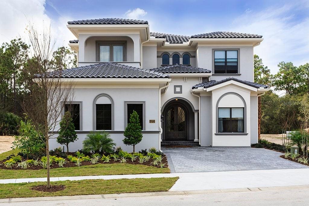 This 7-bedroom custom-built estate in Reunion Resort showcases timeless design, elegant finishes, and a layout created for both relaxation and entertainment. From the moment you enter, you’ll notice artful ceiling details, exquisite tile work, and a wide-open living and dining concept that sets the stage for gatherings of any size. The chef’s kitchen, with dual islands and upgraded appliances, blends function and style at the heart of the home.
Multiple king en-suite bedrooms allow every guest their own private retreat, while two themed bunk rooms, a fully equipped games room, and a cinematic home theater make this residence ideal for families and friends to spread out in comfort.
Outdoors, the expansive screened pool and spa with a soaring two-story enclosure offers a true resort feel, complete with a covered lanai, summer kitchen, and fire pit lounge, all overlooking a tranquil nature preserve for added privacy. The home also maintains an active Reunion Resort membership, opening the doors to three championship golf courses, multiple restaurants, a world-class tennis complex, a private water park, and exclusive community events.