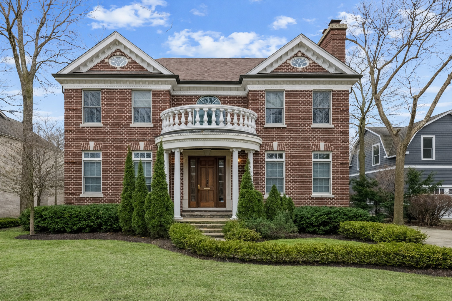 Perfectly positioned in the heart of downtown Glencoe, this all-brick newer construction residence offers a refined blend of timeless craftsmanship and elevated modern living, just moments from boutique shopping, dining, parks, top-rated schools, and the Metra. A gracious foyer introduces rich Brazilian cherry flooring that flows seamlessly throughout the main living spaces, setting a warm, sophisticated tone. The formal living room is anchored by a striking limestone fireplace and framed by stately French doors that open to a distinguished executive office, complete with custom built-ins, intricate wood paneling, and coffered ceilings. Designed for both intimate gatherings and grand entertaining, the dining room showcases exquisite inlaid hardwood flooring and elegant wainscoting, ideally situated just off the kitchen. The chef's kitchen is a masterclass in functionality and style, featuring granite countertops, abundant custom cabinetry, a planning desk, and a center island with prep sink, all complemented by premium appliances including a Sub-Zero refrigerator, Bosch dishwasher, and Viking six-burner range with double ovens and hood. The adjoining breakfast room and family room create a seamless living experience, both overlooking the beautifully landscaped rear grounds and highlighted by a second gas fireplace with stone surround and rich wood mantle. A spacious mudroom and laundry area with LG washer and dryer, ample storage, and thoughtful organization complete the main level. Upstairs, the primary suite is a true sanctuary, featuring a tray ceiling, private fireplace, French doors opening to a serene balcony, an expansive walk-in closet with custom organizers, and a spa-inspired bath with skylight, heated floors, steam shower with body sprays, separate water closet, and a luxurious jetted tub. Three additional bedrooms, each with en suite baths and walk-in closets, offer exceptional comfort and privacy. The fully finished lower level is designed for ultimate versatility and entertainment, offering a large recreation room with brick fireplace, a full wet bar with refrigerator and dishwasher, a built-in workstation, and two additional en suite bedrooms ideal for guests, fitness, media, or creative spaces, along with abundant storage. Additional highlights include a three-car garage with Tesla charger, brand new carpeting, central vacuum, sump pump with battery backup, dual water heaters, Thermazone electronic air cleaner, Toto fixtures, intricate crown molding, and an inviting outdoor patio with Unilock pavers-creating a turnkey residence that effortlessly combines luxury, comfort, and an unmatched in-town lifestyle.