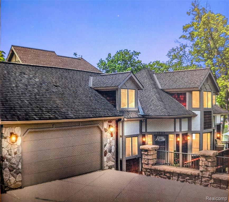 This exquisite four-bedroom custom home on all-sports White Lake seamlessly blends classic charm with modern luxury. The gourmet kitchen features premium Viking appliances and an open layout perfect for entertaining. The upper-level primary suite serves as a true sanctuary, boasting vaulted ceilings with custom fir beams, white oak flooring, and a spa-inspired en-suite with panoramic lake views. The finished walkout lower level offers a full kitchen, bedroom, remodeled full bath and family room with French door access to the patio, perfect for multi-generational living or other uses. Architectural details shine throughout, from mahogany-stained deck beams to the elegant spiral staircase. The exterior is a masterpiece, with over $400k in landscaping including ledgestone tiered walls, a massive 800-square-foot bluestone patio, and a private access drive to the beach. With high-end finishes at every turn, this property offers an unparalleled opportunity for sophisticated waterfront living.