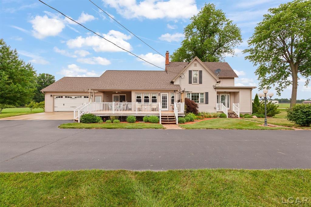 Welcome to your dream retreat!  Nestled on 8 beautifully maintained acres in the desirable Sand Creek School District, this stunning 4-bedroom, 2-bathroom home offers over 2500 square feet of comfortable, updated living space with room to roam both inside and out. Step inside to discover a thoughtfully renovated interior (2014) featuring an updated kitchen with modern finishes, perfect for everyday meals and entertaining.  The expansive primary suite includes a walk-in closet and plenty of space to relax.  Enjoy the convenience of main floor laundry, and unwind in the bright and airy sunroom, perfect for enjoying your morning coffee or taking in the peaceful views.  Approx 3 acres tillable. Outdoor enthusiasts will appreciate the large Trex deck overlooking a beautifully landscaped yard with mature fruit trees. The 2.5 car attached garage provides ample storage and hobbyists will love the large, heated, and insulated 40x60 pole barn - ideal for a workshop, equipment, or recreational vehicles.  A second outbuilding adds even more storage potential. This property offers the perfect blend of rural charm and modern comfort, with room for gardens, recreation, or just soaking in the serenity of country life. Don't miss this rare opportunity- schedule your private tour today!