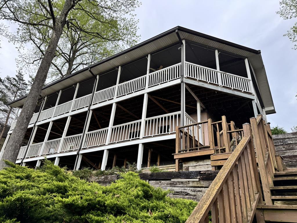 This FULLY FURNISHED mountain cottage offers spectacular year-round, long-range views of the Blue Ridge Mountains, as well as Lake Chatuge. The home is minutes away from downtown Hayesville, NC, as well as the Georgia state line. The home is located in the Smoke Rise community, nestled on a total of 3 acres, with 1 of the acres being located across the street from the home, assuring your control of the beautiful view of the lake! This recently renovated home has an open floor plan and hardwood floors throughout! Entry to the home is protected with keypad access. The backyard mountain views can be seen as soon as you enter the front door! There are new, stainless-steel appliances, with a gas stove, and granite countertops in the kitchen. The kitchen offers bar seating, as well as a breakfast area, with room for a large table and chairs, and a coffee bar. There is also a wood-burning fireplace for those cozy winter nights. There are 3 bedrooms, each complete with walk-in closets and full bathrooms. All bedrooms boast gorgeous, year-round views of the surrounding mountains. The downstairs level offers another large den, which could also be used as a game room. The large decks on the upper and lower area of the home offer amazing views. A full laundry area is located in the attached, 2-car garage/workshop. Recent improvements include new interior paint, a new architectural shingle roof, gutters, a new HVAC system, tankless water heater, and complete home water filtration system.