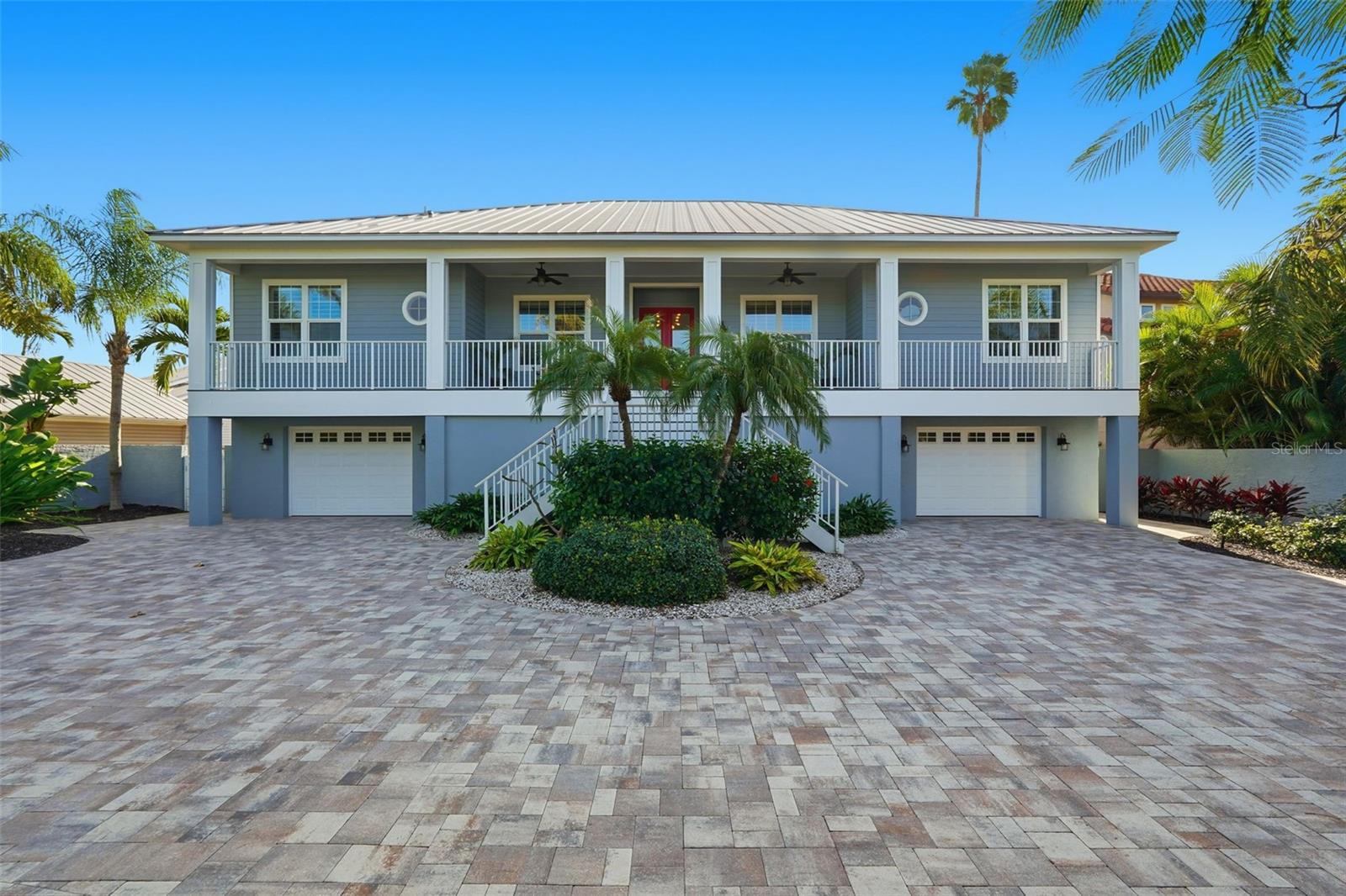 This Key West–style waterfront home offers beautiful wide-open water views, an EXTRA LARGE LOT (.33 acre), and a setting that feels like a private entrance with no through traffic, surrounded by mature trees for exceptional privacy. Elevated construction provided peace of mind during recent storms, with no damage at all to the living area. A major renovation completed in 2023 which includes hurricane-rated windows and sliders, an updated kitchen and bathrooms, tile flooring throughout with carpet in one bedroom. The home features three bedrooms plus an office or den that could easily serve as a 4th bedroom, along with 2.5 baths. Enjoy stunning water views from most rooms, an oversized 756-square-foot garage, and natural gas servicing two fireplaces, an outdoor firepit, grill, and tankless water heater. Plenty of storage with many built-ins and a lot of room on the first floor. Outdoor living shines with an extra-long dock with lifts, an updated pool and spa, outdoor firepit, and an oversized lot. The first floor is currently used as an expansive game room and offers endless possibilities as an office, playroom, or additional living space. Carefree metal roof and durable Hardiplank siding complete this exceptional waterfront property. Super convenient location, walk to the beach, many restaurants and close to all major thoroughfares. Schedule your appointment to see this spectacular home.
