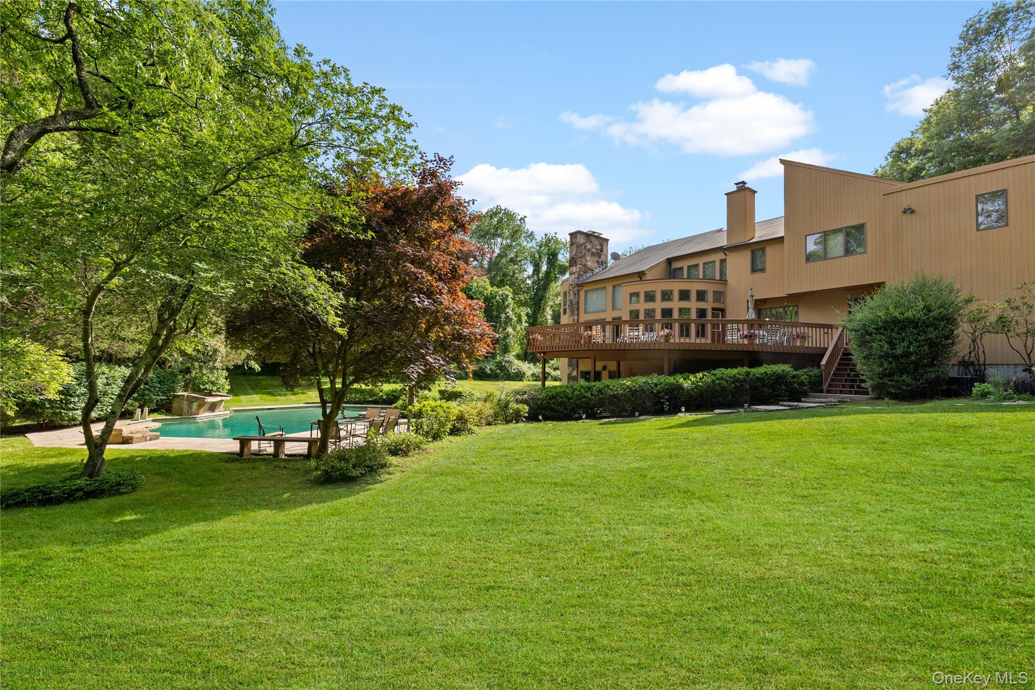 Sleek California Contemporary on 4+ acres at the end of a beautiful street with pool and privacy yet in the heart of it all.  This 6 plus bedroom masterpiece was custom built with open floor plan, soaring ceilings, and walls of glass to capture the breathtaking property and views.  Top materials and finishes throughout, loads of amenities and meticulously built and maintained by current owners.  Ample indoor/outdoor entertaining space/home office options plus comfortable guest quarters. Outdoor oasis of rolling laws, beautiful pool and spa, enormous deck/patio space directly accessible from kitchen and lower level. Incredible lower level that serves as pool house/multi purpose recreation room/guest quarters/home office, gym and more.  The perfect blend of modern, "feel good" space, incredible exposure, natural light and beauty plus exceptional balance of privacy, convenience and inherent value.