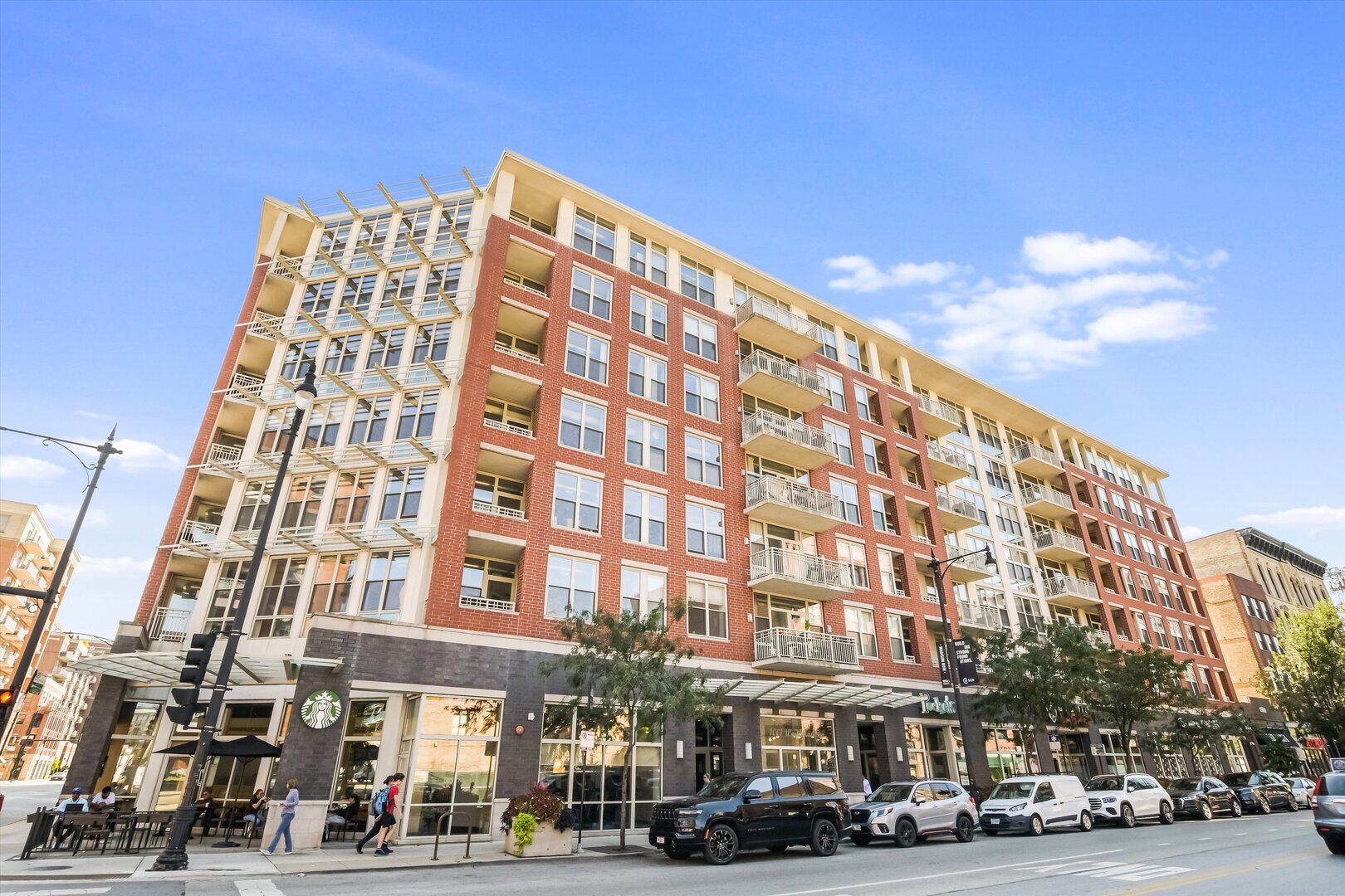 Welcome home to your new 2 bedroom, 2 bathroom condo! Bright, quiet, and filled with natural light, this top-floor condo offers high ceilings, a fireplace, and floor-to-ceiling windows framing stunning skyline views. The open living space flows seamlessly into the updated kitchen with shaker cabinetry, quartz countertops, stylish backsplash, and newer stainless steel appliances. The spacious primary suite comfortably accommodates a king bed plus a home office or workout area. The en-suite bath features a walk-in shower and dual vanities. A fully enclosed second bedroom provides flexibility for a guest room, office, or nursery. Step outside to your private covered balcony, perfect for relaxing, taking in the views at the end of the day, or grilling and entertaining. Enjoy full-amenity living at its finest with a large fitness center, common area sun deck with picnic tables, and an on-site Starbucks. Heated garage parking is included in the price. Unbeatable location convenient to transit, with the 20 bus stop right outside your front door, and just steps away from world-class dining, shopping and parks in West Loop and Fulton Market. Schedule your tour today!