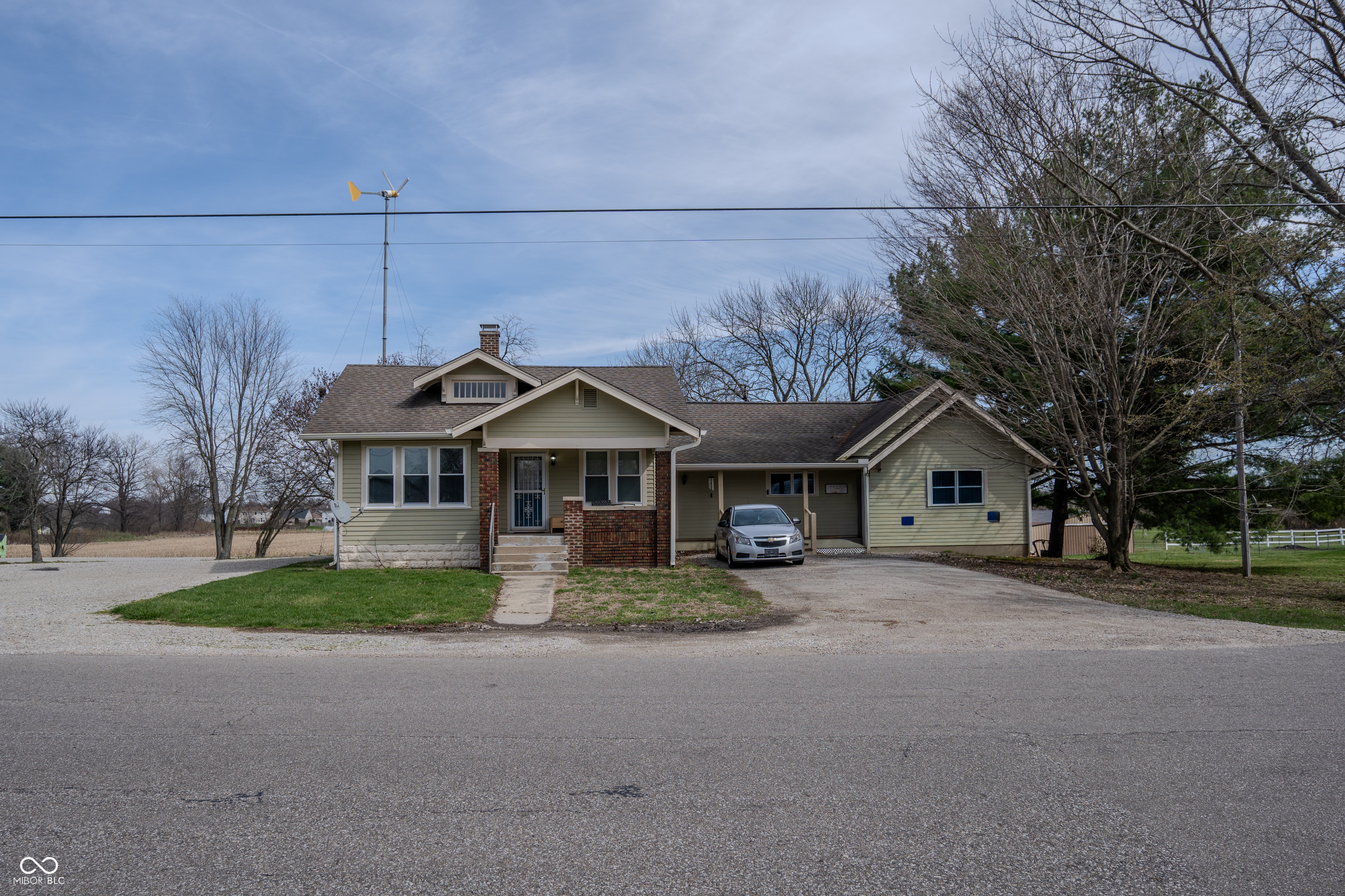 Set on 8.63 acres in Whiteland, this 3,157-square-foot property offers a rare combination of space, flexibility, and privacy-just minutes from major highways, shopping, and everyday conveniences. Designed for multi-generational living or adaptable use, the home is currently configured as a residence with separate in-law quarters, with the option to open the wall and create one seamless living space. The primary residence features three bedrooms, a full bath, a welcoming great room, kitchen with breakfast area, dining area, laundry, and an additional family room in the basement-ideal for entertaining or everyday living. The in-law quarters include a private primary bedroom, full bath, kitchen with breakfast area, office, laundry, and a spacious great room highlighted by a cathedral ceiling and loft, creating an open and airy feel. Outdoor living is just as impressive. A covered deck overlooks the in-ground pool and expansive acreage, offering peaceful views and plenty of room to relax, entertain, or enjoy the outdoors. An oversized detached two-car garage provides ample space for parking, hobbies, or a workshop. The property also includes a 75' x 50' pole barn equipped with three offices, two bathrooms, and a kitchen while keeping the shop area 65x50, making it ideal for a home-based business, storage, or creative use. Two additional outbuildings add even more storage and versatility. This one-of-a-kind Whiteland property delivers a true rural setting with the convenience of nearby interstates-perfect for buyers seeking land, flexibility, and room to grow without sacrificing accessibility.