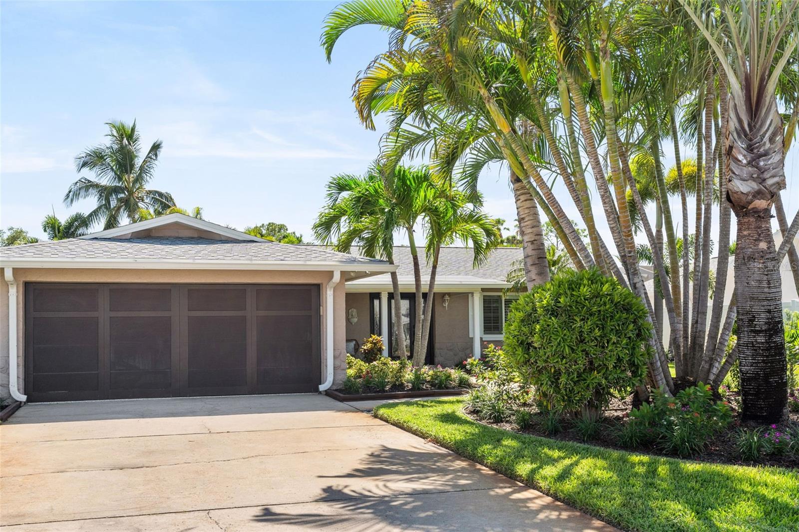One or more photo(s) have been virtually staged. Enjoy the best of coastal living on the island community of Vina Del Mar—just a short golf cart ride to Pass A Grille Beach! This beautifully remodeled 3-bedroom 2-bath home offers 1910 heated square feet, including a bright enclosed sunroom with 320 additional heated square feet. A versatile bonus office provides the perfect work-from-home space or can easily be converted into a fourth bedroom. The new kitchen features quartz countertops, solid wood cabinetry, stainless steel appliances, breakfast bar and opens to the dining area and sunroom—ideal for entertaining, and also leads to a private landscaped backyard with room for a pool. Wood-look plank tile flooring runs throughout, and both bathrooms have been beautifully renovated with quartz countertops and designer tile. Additional upgrades include a new roof (2022), updated electrical panel (2022), new water heater (2026), interior doors, garage door and epoxy flooring, hurricane-impact doors and windows (excluding sunroom), recessed lighting, ceiling fans, plantation shutters, PVC vinyl fencing, and Mini-split AC systems in both garage and sunroom. Vina Del Mar is close to a public boat ramp, marina, waterfront restaurants, shopping, vibrant downtown St. Petersburg and I-275 for an easy commute to Tampa, Bradenton or Sarasota. Move right in and start enjoying the Florida island lifestyle – make an appointment today!