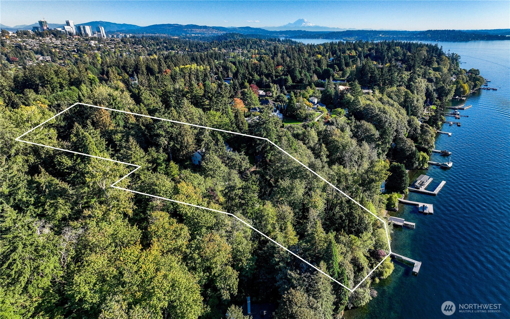 Evergreen Lakeshore Preserve. 3 wooded acres on Medina’s ultra-affluent Gold Coast: 215 ft Lk Washington waterfront, accessed by private hillside tram, with 70-ft dock; 1938 5170 SF main residence; various smaller outbuildings. Panoramic view of boat traffic, vivid sunsets, serene Olympic Mtns. Conservation easement prevents subdivision, protects fragile habitats, creates privacy and peace – minutes from energy and excitement of Bellevue tech, world-class restaurants and retail, fabled mansions of founders and magnates. Erect your dream compound! Provision for renovation/replacement of existing structures within original footprint; city zoning allows vertical expansion. Extensive documentation includes architect’s feasibility study.