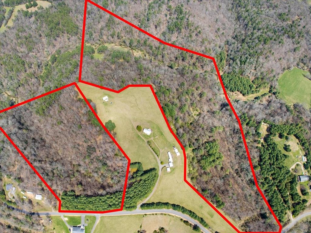 Discover a truly rare opportunity in the Woodlawn area with this unrestricted two tract offering at 110 Highlander Lane, Woodlawn, VA totaling 34.46 acres across 11.96 acres and 22.5 acres. Both tracts are all wooded with marketable timber and each has its own access from Buckwoods Road, with entrances that should need only minimal work to create driveways. The seller prefers to sell the tracts together, offering a unique chance to secure a larger, private landholding that's still convenient approximately 5 miles to I-77 and about 20 minutes to Galax or Hillsville. While there are no utilities currently in place, they appear to be able to be brought in without major difficulty for a future home, cabin, or weekend retreat. One of the most appealing features beyond the natural beauty, privacy, seclusion, and true solitude is the extensive time the owner has invested countless hours meticulously cutting and clearing internal roads throughout both tracts, making the property far easier to explore than typical wooded acreage. The land is best accessed primarily with 4-wheel drive if you don't mind driving it in the woods, and it can definitely be enjoyed by ATV/UTV, with established trails and plenty of room for recreation. The owner has also marked the boundaries, giving you a major head start in understanding the layout and walking the property to identify potential building sites or favorite camping spots. The 22.5 acre tract adds extra character with multiple springs and a beautiful view toward a nearby creek that runs close to the property. Wildlife is abundant here bear, deer, turkey, and more making it a great fit for hunters and outdoor enthusiasts alike. Plus, you're within about 1 mile of Crooked Creek, where you can fee-fish for trophy-size trout, and a short drive to destinations like the Blue Ridge Parkway, New River, New River Trail, and the Blue Ridge Music Center. This is one you truly must see in person to appreciate all it has to offer.