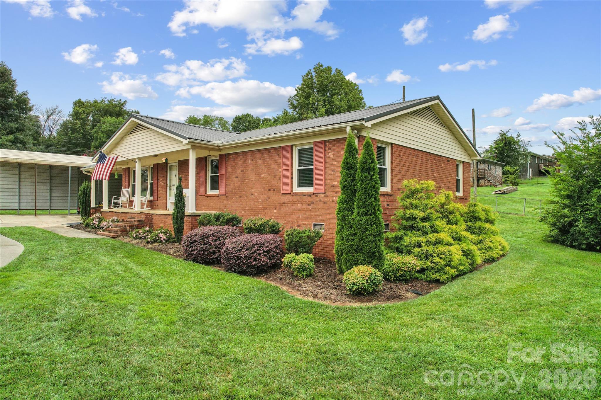 Welcome home to this charming all-brick ranch situated on a desirable corner lot with inviting curb appeal and no HOA. A classic rocking chair front porch welcomes you inside, where you'll find a spacious living room, a functional kitchen, three bedrooms, one full bath, and a convenient half bath. Outside, enjoy the durability and low maintenance of Trex-style decking, perfect for relaxing or entertaining. A detached garage with power offers excellent space for parking, storage, hobbies, or a workshop. The metal roof provides lasting peace of mind, while the large laundry room adds everyday convenience. Whether you're a first-time homebuyer, looking to downsize, or searching for an investment opportunity, this well-maintained home offers comfort, functionality, and value in a convenient Kannapolis location.