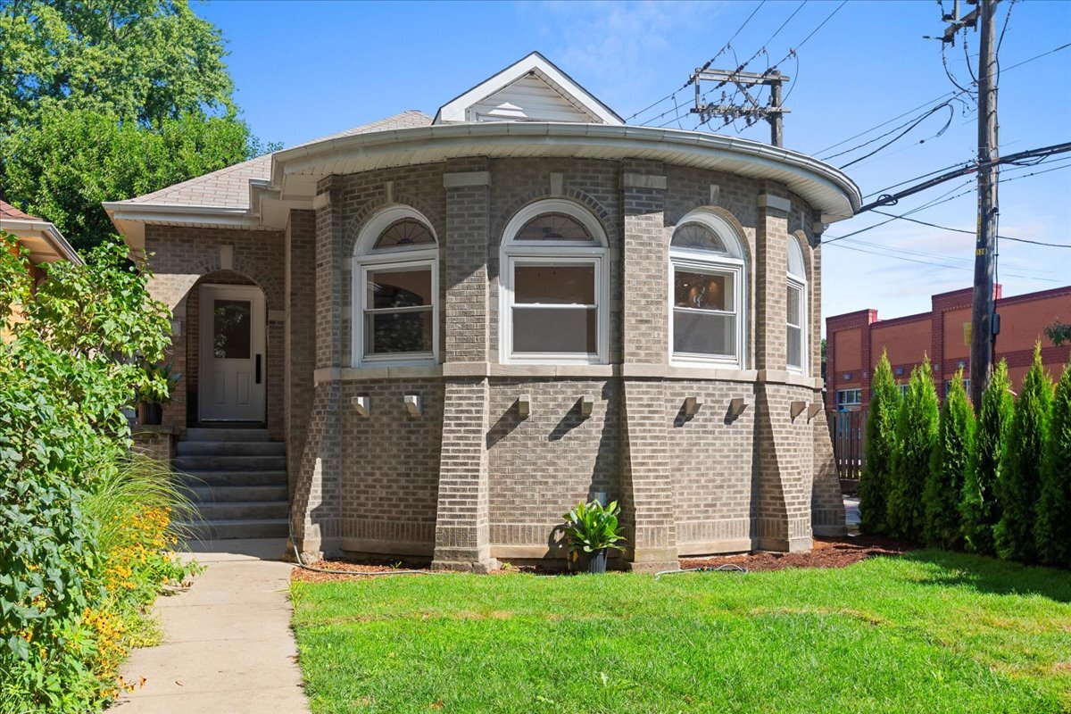 Welcome to this rare 6-window-wide Chicago bungalow, fully reimagined in 2025 with brand-new finishes, mechanicals, and modern updates throughout while honoring its timeless charm. Inside, you'll find soaring ceilings, 6 spacious bedrooms plus a den, and a flowing layout designed for today's lifestyle. The expansive living and dining room features refinished hardwood floors, abundant natural light, and room to entertain on a grand scale. The chef's kitchen shines with custom cabinetry, quartz countertops, and stainless steel appliances, opening seamlessly to the dining area. TWO ensuite first floor bedrooms for ease of use, and four new skylights enahnce the light and flow. The lower level offers incredible versatility with a huge living space, KITCHENETTE (not photoed - stove to be added with a refrigerator, cabinetry and sink), and flexible room for a gym/playroom, in addition to a full bathroom perfect for a guest suite. Laundry connections are available BOTH upstairs and downstairs. Out back, enjoy a 2-car brick garage plus additional parking pad, perfect for a third car or doubling as an outdoor entertaining area. Located on a quiet tree-lined street in West Ridge, just steps from Indian Boundary Park's gardens, playgrounds, tennis courts, and cultural center, this home offers the best of neighborhood living with easy access to shops, restaurants, schools, and transit. Many updates include windows/tuckpointing/roof within the last 10 years, and newer mechanicals!