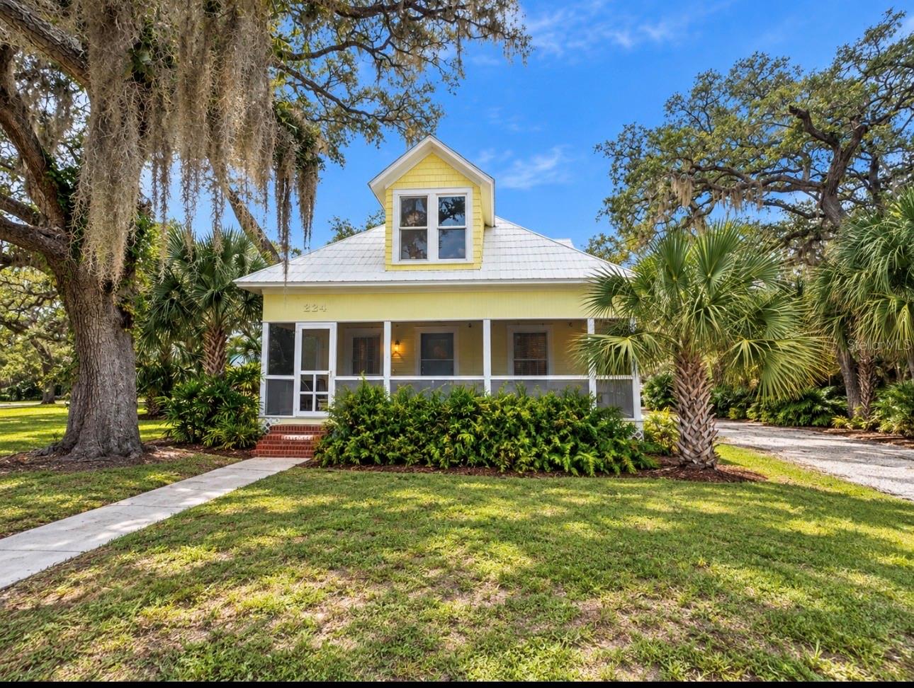 More photos coming soon! LOCATION, LAND, HISTORY AND ENDLESS POSSIBILITIES! Welcome to 224 Albert Street, an incredibly rare property tucked away in the heart of Dunedin, just ONE BLOCK from beautiful Edgewater Drive and minutes from Downtown Dunedin, the Dunedin Marina, Edgewater Park, the Pinellas Trail, restaurants, breweries, boutiques, festivals and everything that makes this coastal community so special. It’s hard to imagine a better location to experience the Dunedin lifestyle!Originally built in 1909, this charming historic home has been completely gutted and beautifully renovated into a 3-bedroom, 2-bath home, blending the character of Old Florida with the comfort and style of today. A beautiful screened-in front porch welcomes you home and creates the perfect spot for morning coffee, evening cocktails or simply enjoying the peaceful surroundings.As you enter the home, you’re greeted by a warm and inviting living room centered around a beautiful brick wood-burning fireplace—a feature that adds so much character and charm and feels perfectly at home in a property with more than a century of history. The thoughtfully renovated interior offers a bright, welcoming feel while still celebrating the unique personality of this special home.But what truly makes this property magical is the SPACE. Situated on approximately .43 acres, the home opens to a large rear deck overlooking the pond and an expansive backyard that feels like your own private oasis right in the middle of Dunedin. There is so much room to entertain, garden, play or completely transform the property into the retreat you’ve always imagined.The large one-car garage includes an additional storage room with a NEW wall-unit A/C. This area is not currently included in the home’s heated square footage, creating even more possibilities for a home office, gym, art studio, workshop, bonus room or potential additional living space.And then there is the incredible MF-15 zoning! Dream big—create your own private compound, design a spectacular pool and oversized lanai, build a new garage with an ADU above, or explore the potential for an additional home or residences on the property. Keep the beautifully renovated 1909 home as the centerpiece and create something truly extraordinary around it. Whether you envision a private estate, multigenerational property, additional living space or future investment opportunity, the possibilities here are truly endless. Buyers should independently verify all permitted uses, density and development options with the City of Dunedin.There are properties you simply have to experience in person, and 224 Albert Street is one of them. Nearly half an acre, a beautifully renovated historic home, pond views, incredible outdoor space, unique zoning and an unbeatable location just a block from Edgewater Drive—this is a rare opportunity to own a truly special piece of Dunedin.