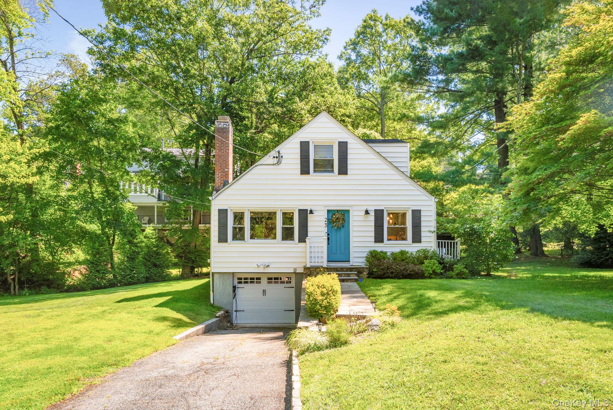 Welcome to 23 Brookside Place in Pleasantville, NY — a beautifully maintained, energy-efficient home set on three tax lots with room to expand. The main level offers timeless details including crown and baseboard molding, a spacious entry foyer with coat closet, and a bright living room featuring recessed lighting and a wood-burning fireplace with wood mantle and stone surround. The updated eat-in kitchen is designed for both everyday living and entertaining, showcasing granite counters, tile backsplash, slow-close cabinetry, GE Profile built-in microwave, Bosch dishwasher, ThinQ refrigerator with water dispenser, GE induction stove, and a sliding glass door that opens to a wood deck and stone patio. A renovated full bath with new vanity and bathtub, along with two comfortable bedrooms—each with new ceiling fans (2024) and closets—complete this level. Upstairs, the primary suite offers recessed lighting, a spacious closet, an oversized walk-in closet/dressing area that can be converted back to a fourth bedroom, and a beautifully updated tiled bathroom with walk-in shower, new vanity, and wainscoting. The lower level includes a workbench, LG washer and dryer, and direct access to the one-car garage with epoxy floor and upgraded 200-amp electrical panel (2024). Additional features include hardwood floors and updated windows throughout, freshly painted interior, a flagstone walkway to the front door, new roof (2023), radon mitigation system (2023), new landscaping (2022), and a seven-zone internet-connected in-ground sprinkler system. With its large property, updated systems, and inviting outdoor spaces, this home blends charm, comfort, and modern efficiency in an ideal Pleasantville location.