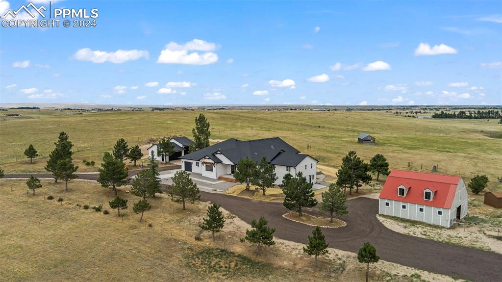Life is Sweet on this Serene 39 Acre Equestrian Estate exuding Pikes Peak and Mountain Vista Views! Just 20 minutes from Falcon, 35 minutes to Powers Blvd., this Newly Remodeled homes offers premium amenities that blend comfort, contemporary living, and entertainment. Welcomed by Soaring Vaulted Ceilings, the Great Room showcases a chic gas fireplace and seamlessly flows into the Open-Concept Kitchen. With Quartz countertops, ample walk-in pantry, and top tier Stainless Steel appliances including a 6-burner gas range/double oven, cooking and entertaining can be a breeze. Off the kitchen presents a janitor’s closet, mud room leading to the attached garage, and main level laundry with a sink. Elevated by Accordion doors and Windows, indoor-outdoor living beckons to the immense deck, perfect for entertaining, and taking in the breathtaking views. The Primary Suite nestled in a wing of its own, boasts Vaulted Ceilings, Chandelier, Chandelier Ceiling Fan, USB wall outlets, and enough space for a sitting area or custom flare. The adjoining primary bath features high-end finishes displaying a separate bath and shower, flowing to the robust Walk-in closet. The 3 main-level bedrooms with a full bath are on the other end of the home, with stairs leading to the Fully Finished Walk-out Basement/separate Living Area. With Luxury Vinyl floors, the additional 2 bedrooms, 2 bathrooms, Laundry area and Dog Wash, Living Room, Recreation Room, Flex Room, and Full Eat-in Kitchen with Stainless Steel appliances and stone flooring take an additional living area to a new level! Outside further enjoy the Equestrian amenities of a 6-stall Stable, Loafing Shed, and Corral. Additional luxuries are the Heated Oversized detached 3-car garage, 4 Zoned Surround Sound throughout, Nest thermostat, a Safe room or Wine Cellar, 2 Private Entries, 2 RV Hookups, and a Zip-line. Make this house your next home or take the opportunity to make it a dreamy Wedding Venue, Horse Lodge, or Destination Retreat!