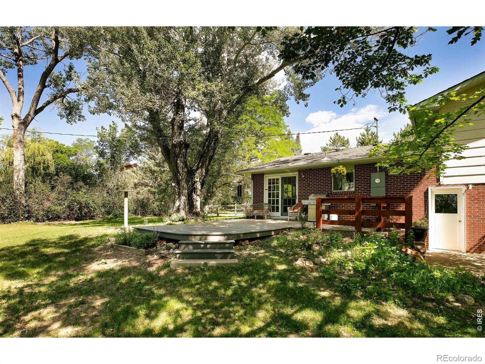 RARE! Opportunities on Pleasant Ridge Rd are few and far between. Just minutes from downtown Boulder, this exclusive .87 acre Boulder County enclave feels worlds away. Mature cottonwoods line the road, open farmland and Boulder County open space define the surrounding landscape, and a peaceful parklike setting unfolds from the moment you arrive.The property is serviced by Lefthand Water and includes a 1/40 share of Farmers Ditch, which meanders through the backyard. Equipped with a pump for irrigation, the ditch also serves as a seasonal water feature with charming foot bridges that enhance the landscape. Bring your renovation ideas to the existing three-bedroom split-level home, or start fresh and build your dream home in this exceptional location. Zoned Agricultural, the property offers winter Flatiron views and is surrounded by open farmland, creating a sense of privacy and open space that is increasingly difficult to find. The spacious and private yard features expansive lawns, flowering lilies, and a secluded setting near the end of the road. The neighborhood borders Boulder County open space and is conveniently located near Boulder Reservoir, with quick access to major highways and limitless recreational opportunities. Enjoy the tranquility of a country setting without sacrificing convenience. Shopping, CU Boulder, and Boulder's restaurants, arts, and cultural attractions are all just 5 to 10 minutes away. A truly special opportunity in one of Boulder County's most desirable neighborhoods.