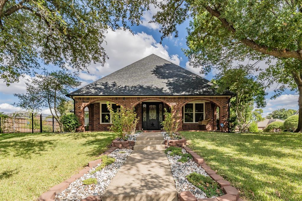 True Showstopper in the Heart of the Mid-Cities! This spectacular, completely updated 4-bedroom home offers an exceptional blend of luxury, comfort, and functionality, with 3 spacious living areas and an incredible private backyard retreat. Step outside to your own resort-style oasis featuring a sparkling pool and spa plus an impressive covered outdoor kitchen & living area designed for entertaining. The outdoor kitchen features a built-in grill, refrigerator, sink, abundant countertop workspace, ceiling fans, and a TV mount already in place. A high bar with a built-in fire heater creates the perfect spot for enjoying cool evenings, watching the game, or gathering with friends and family. With the pool, spa, covered entertaining space, and privacy, this backyard truly feels like an extension of the home. Inside, the chef’s kitchen is a standout with stunning granite countertops, white cabinetry, a large island, double ovens, breakfast bar, and built-in wine cooler overlooking the living room. The expansive main living area features a gorgeous brick fireplace with gas logs & custom built-in bookshelves, adding warmth and character. A second living area offers flexible space for an office, playroom, or lounge, while the third living area is a beautiful sunroom overlooking the backyard. The luxurious downstairs primary suite is a private retreat with 2 walk-in closets and an ensuite bath featuring granite countertops, dual sinks & vanities, a freestanding soaking tub, and separate shower. Upstairs are 3 generously sized bedrooms with walk-in closets, ceiling fans, built-in shelving, and window seating along with an updated full bath featuring dual sinks. The utility room includes built-in cabinetry, sink, & space for a freezer. The oversized garage offers built-in shelving for storage. Thoughtfully updated & move-in ready, this home offers the perfect combination of indoor comfort, exceptional outdoor living, and convenience—just 5 minutes from DFW Airport!